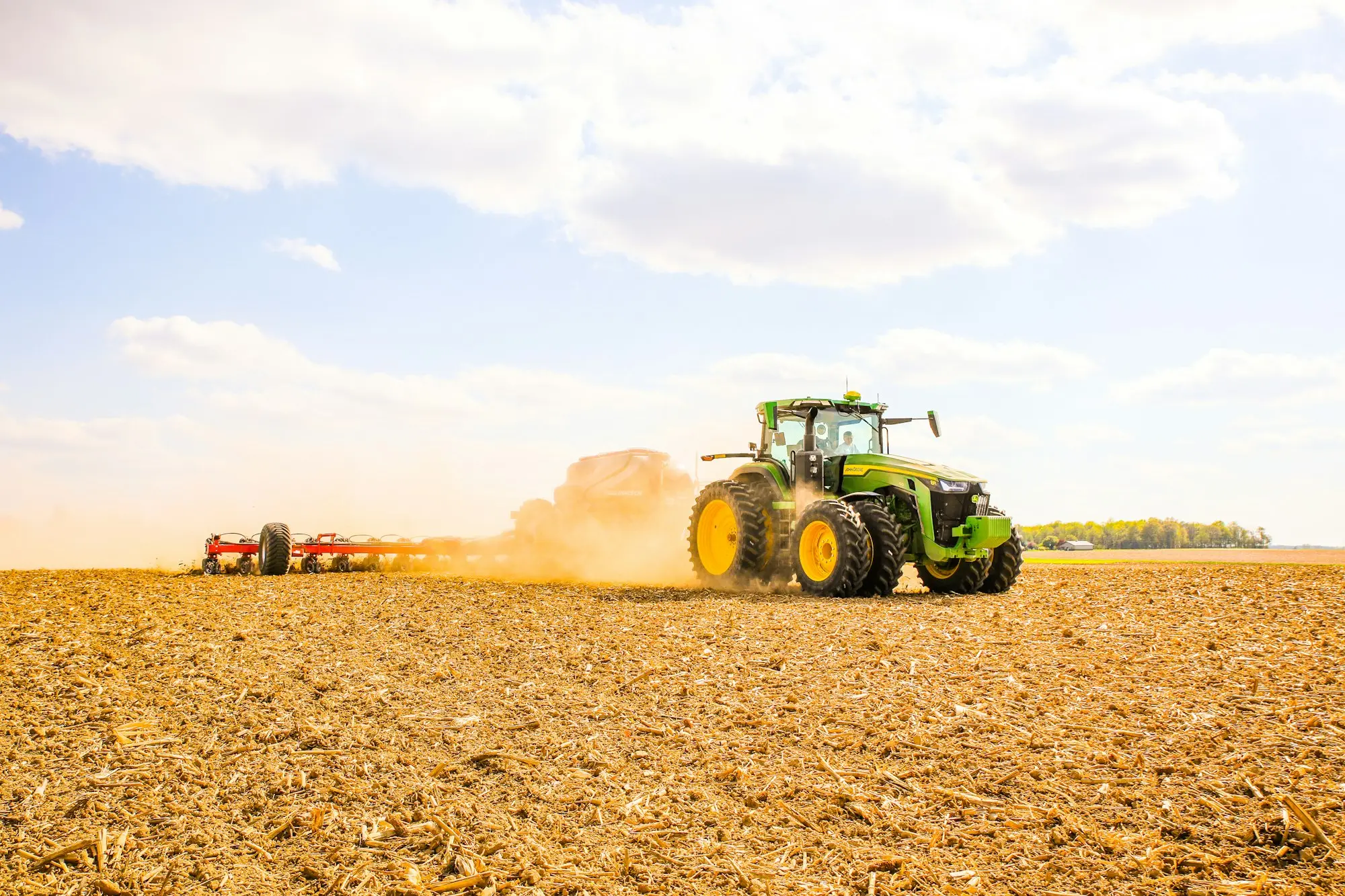 Tractor working a paddock at sunset, funded with agricultural machinery finance