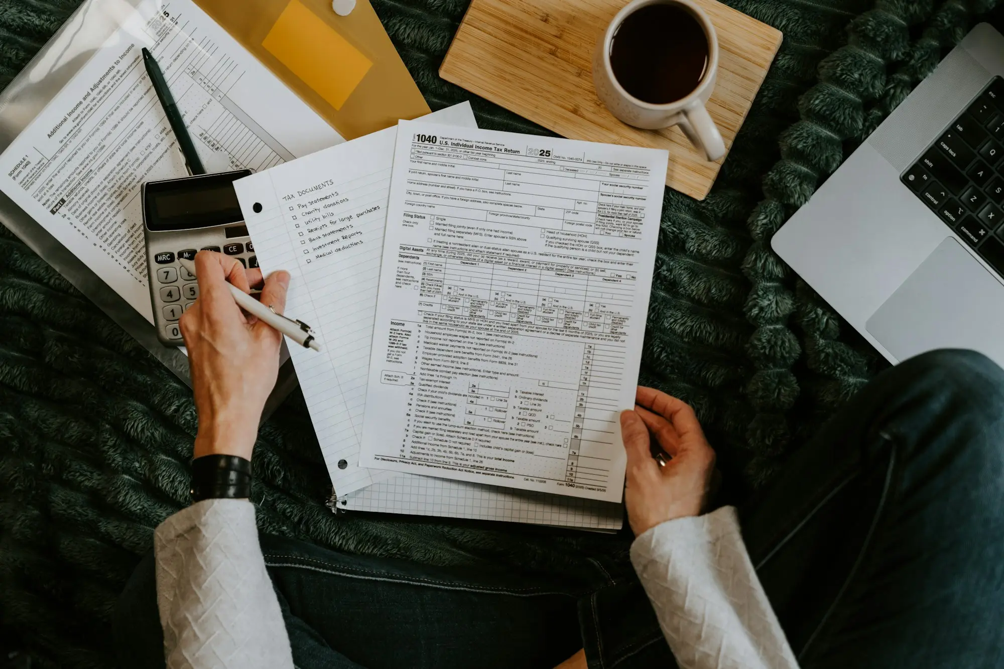Business owner at a desk reviewing an ATO amended assessment after an audit, working out how to pay the audit bill
