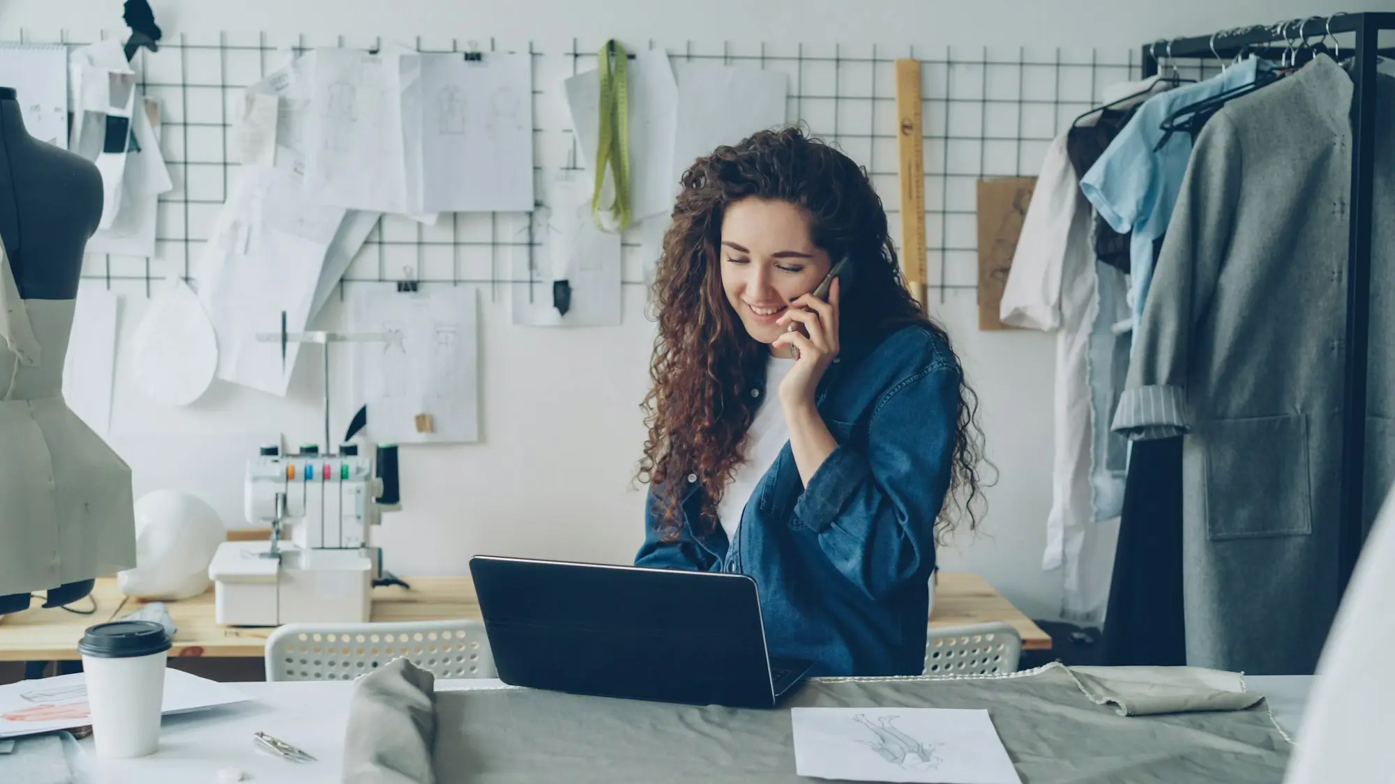 Small business owner managing a business line of credit on a laptop in her workshop