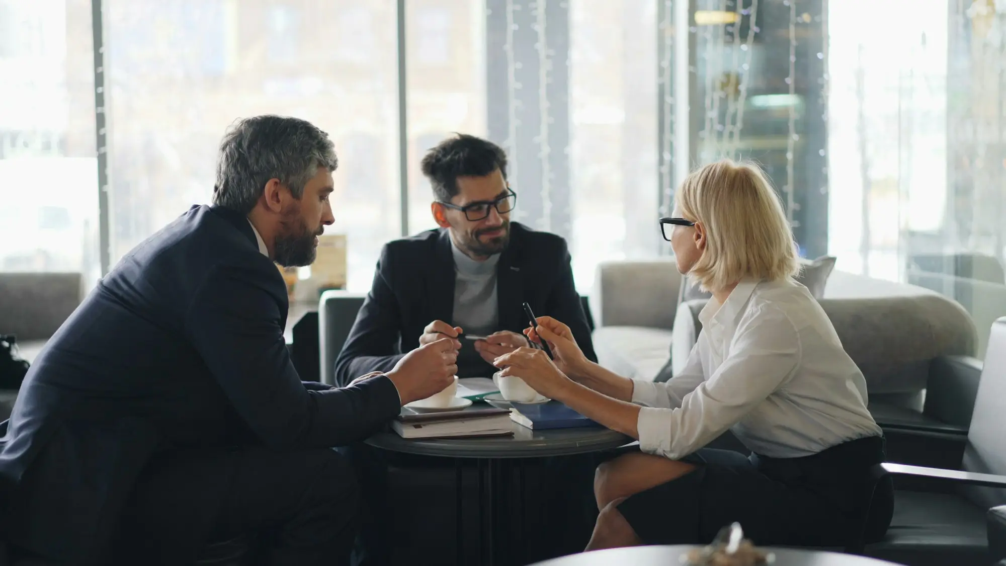 Business owner reviewing the interest deduction on a business purchase loan with her accountant at a desk