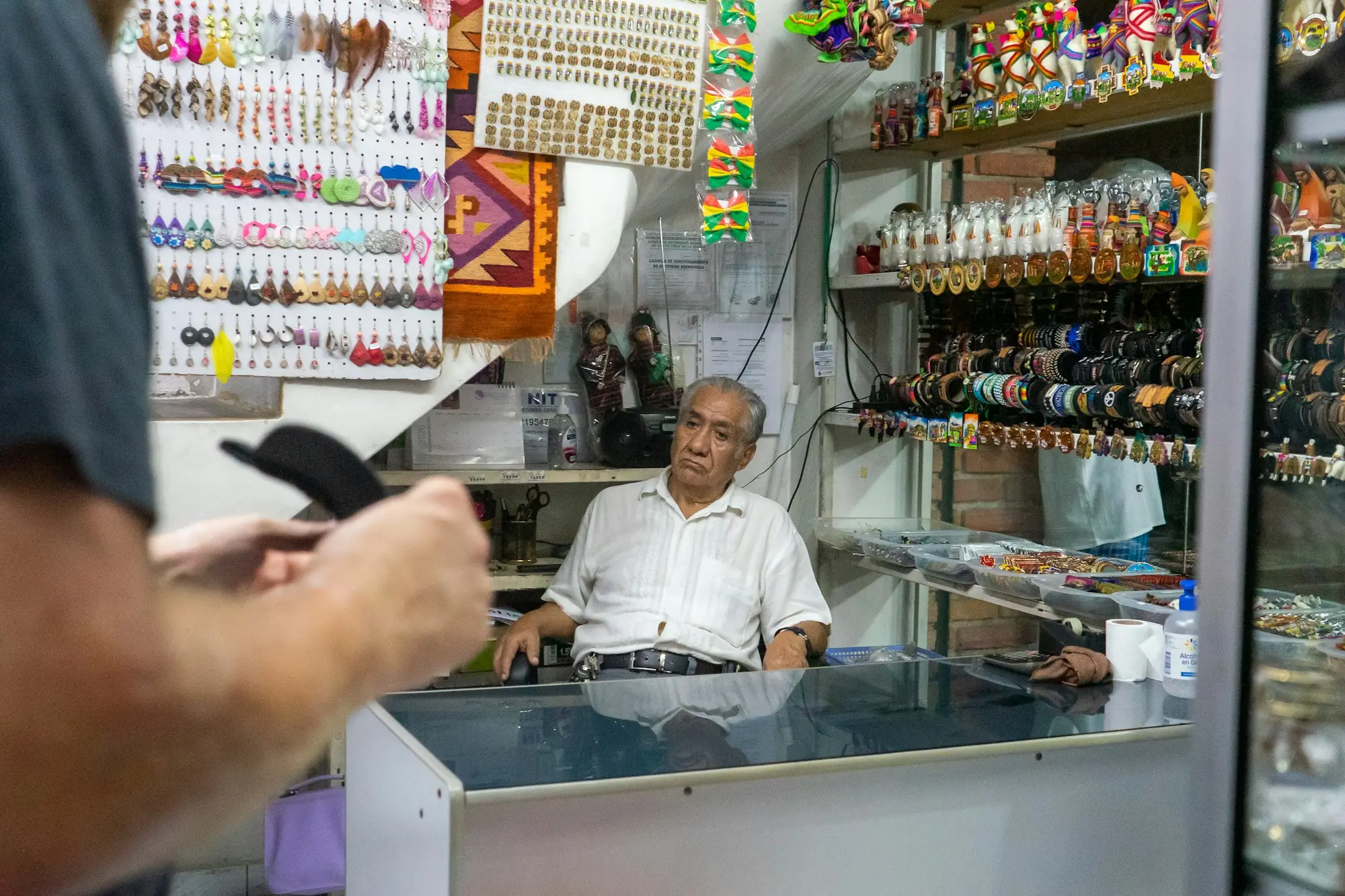 Career changer standing behind the counter of a small shop she is buying with no prior industry experience