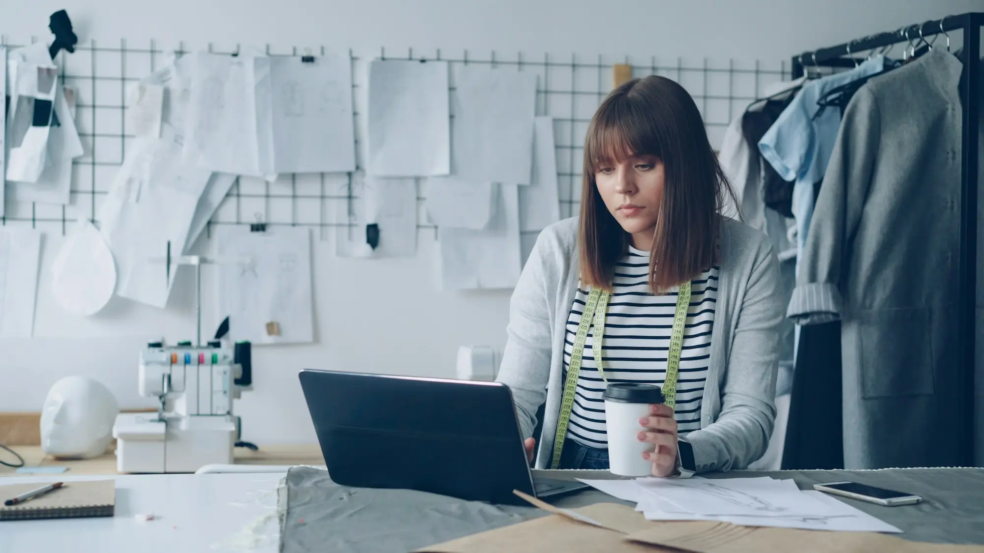 Small business owner checking invoices and cash flow on a laptop