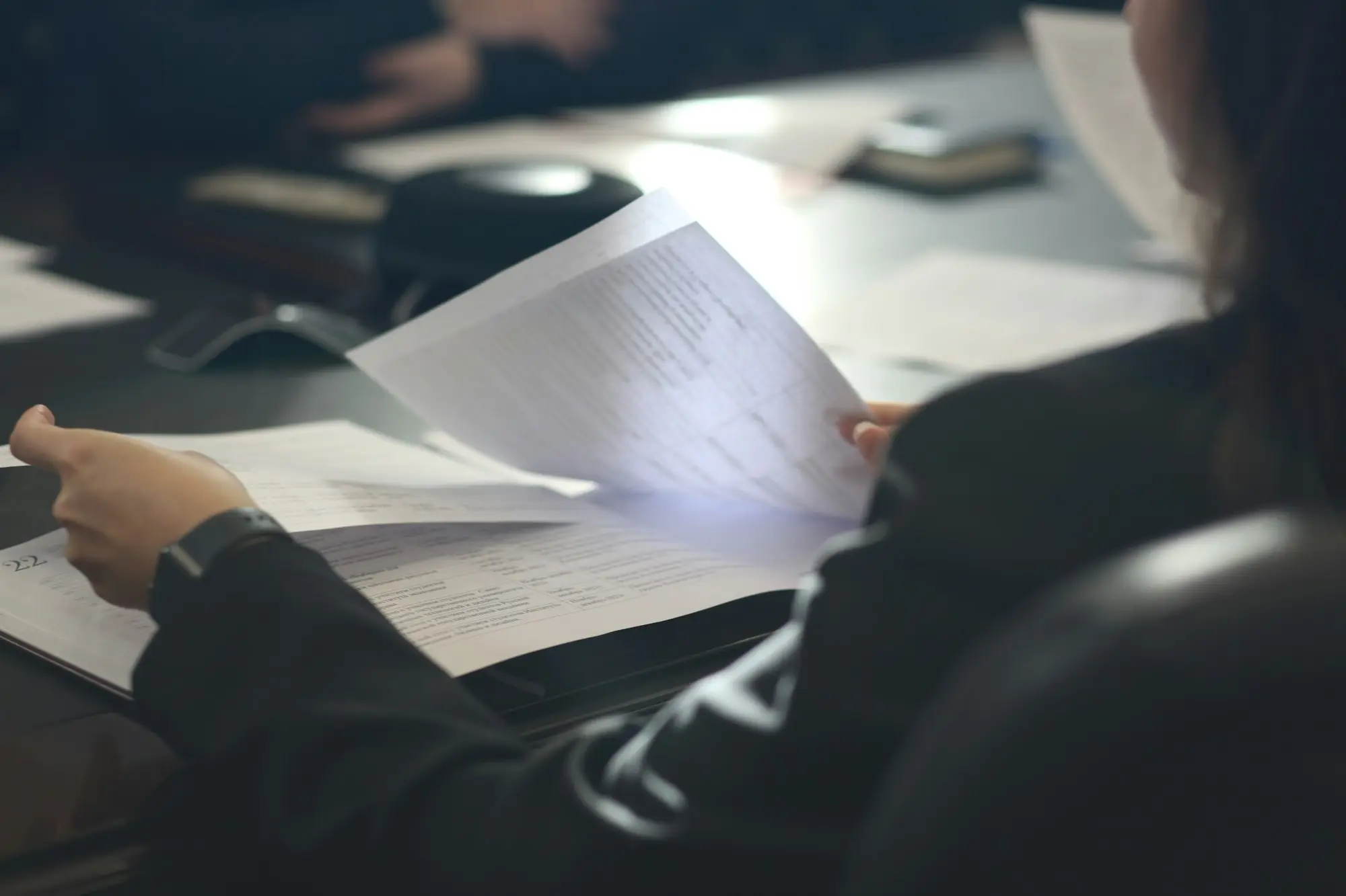 Company director reviewing payroll records and a state payroll tax notice before applying for a caveat loan