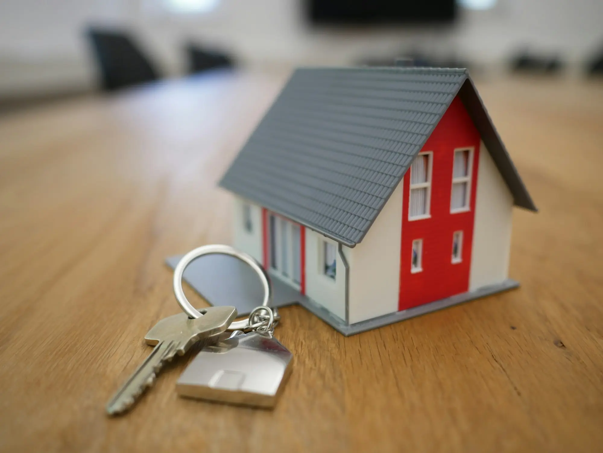 Keys being handed over outside a newly built townhouse at settlement, after the developer supplied an ATO clearance certificate