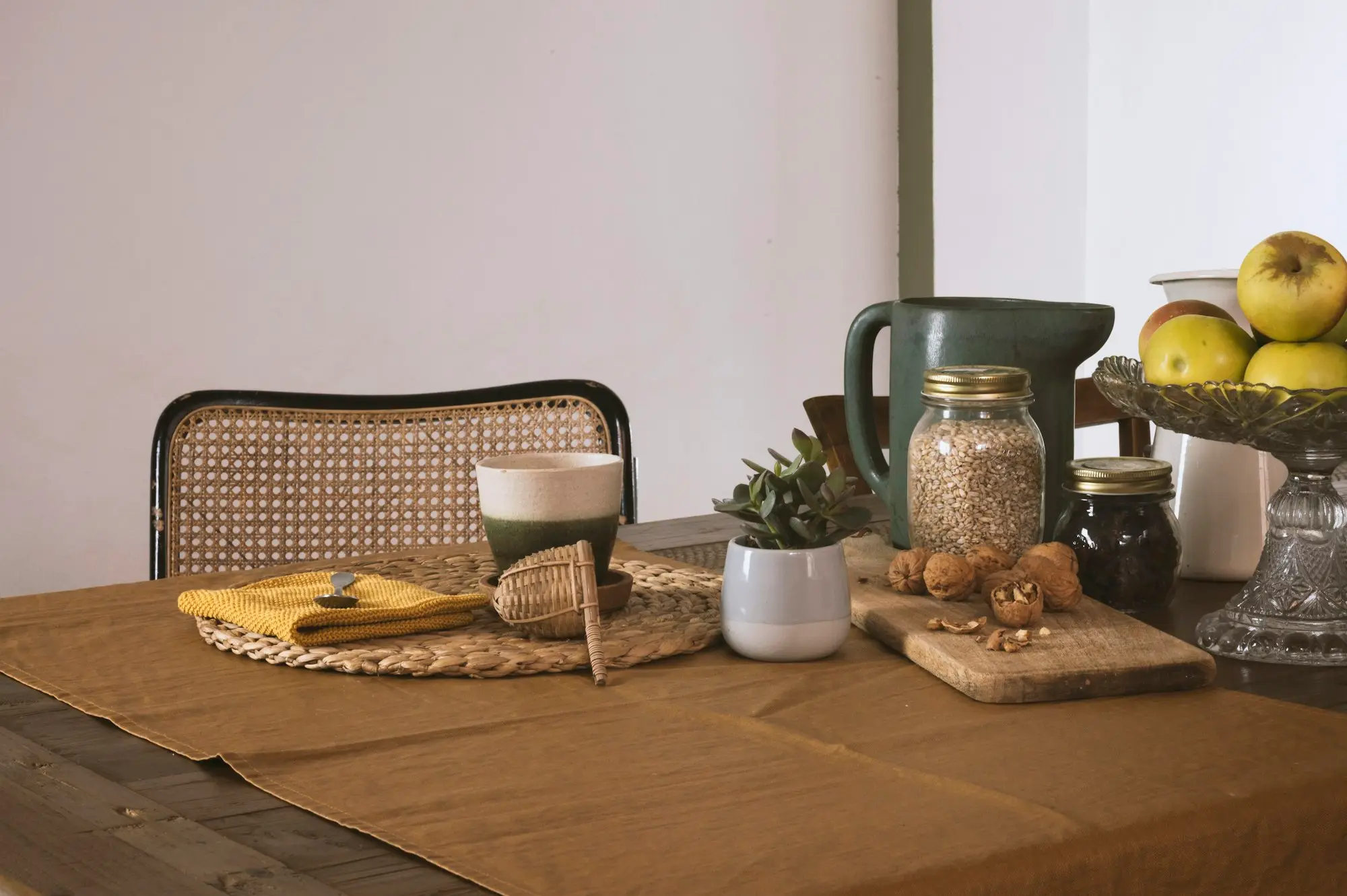 Surviving co-owner sorting property title paperwork at a kitchen table before borrowing against the home for the business