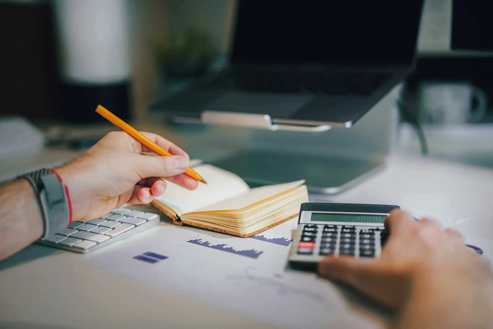 Business owner and accountant mapping debts across two companies and a trust before a debt consolidation