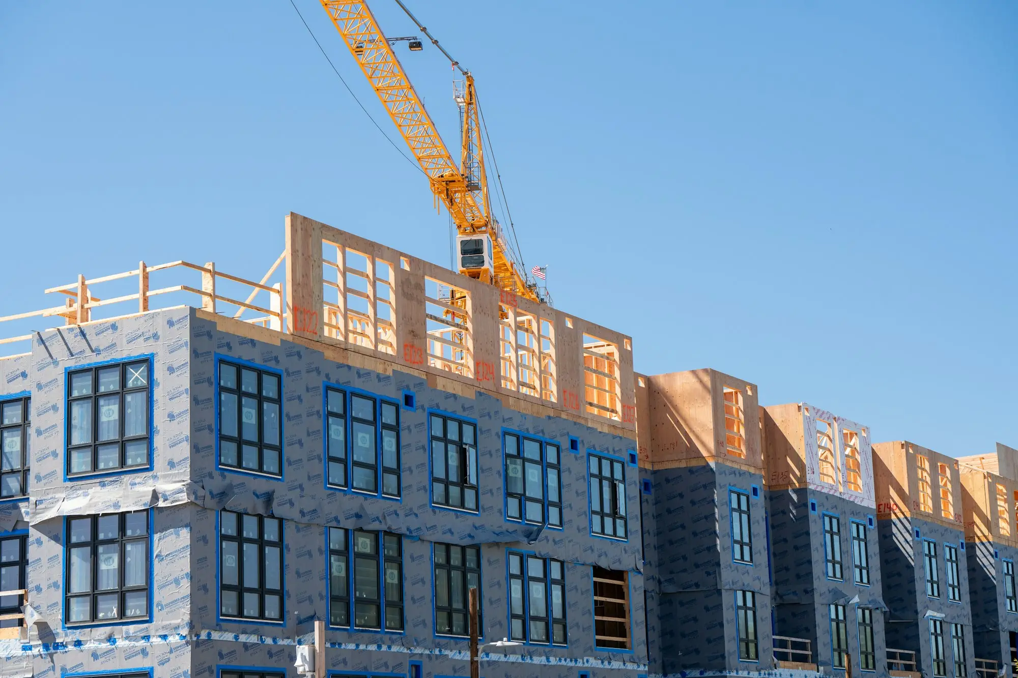Tower crane over a residential building under construction with development finance