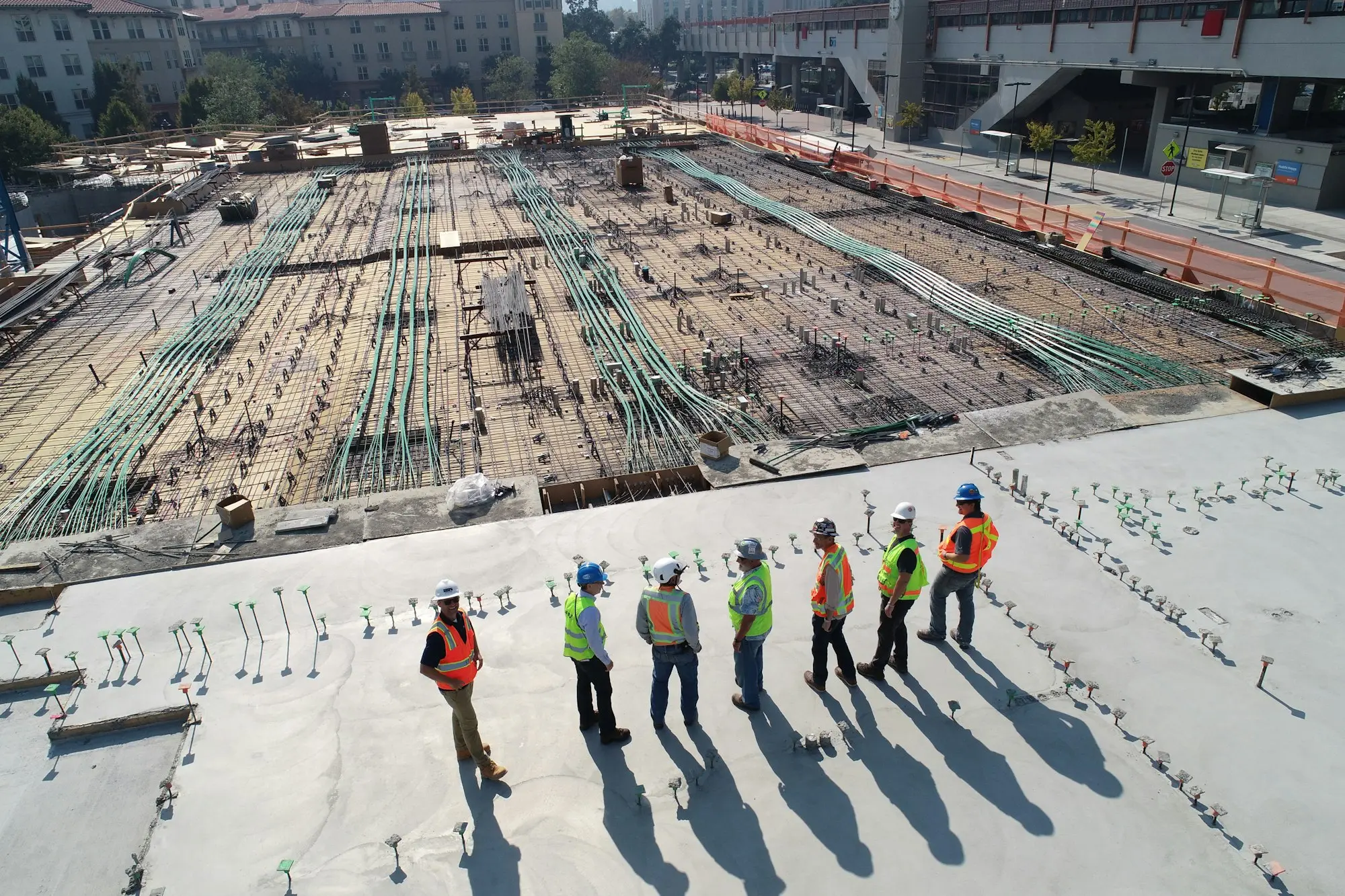 Developer and builder discussing a written variation on a townhouse building site before sending it to the construction lender
