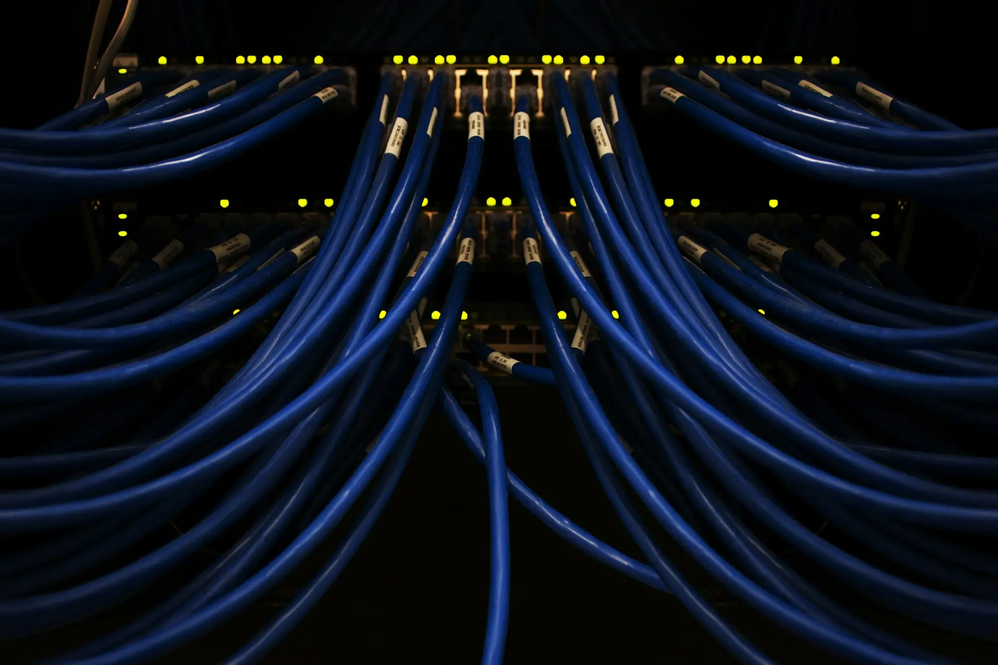 IT technician installing a firewall in a network cabinet, illustrating cyber security upgrade finance for a small business