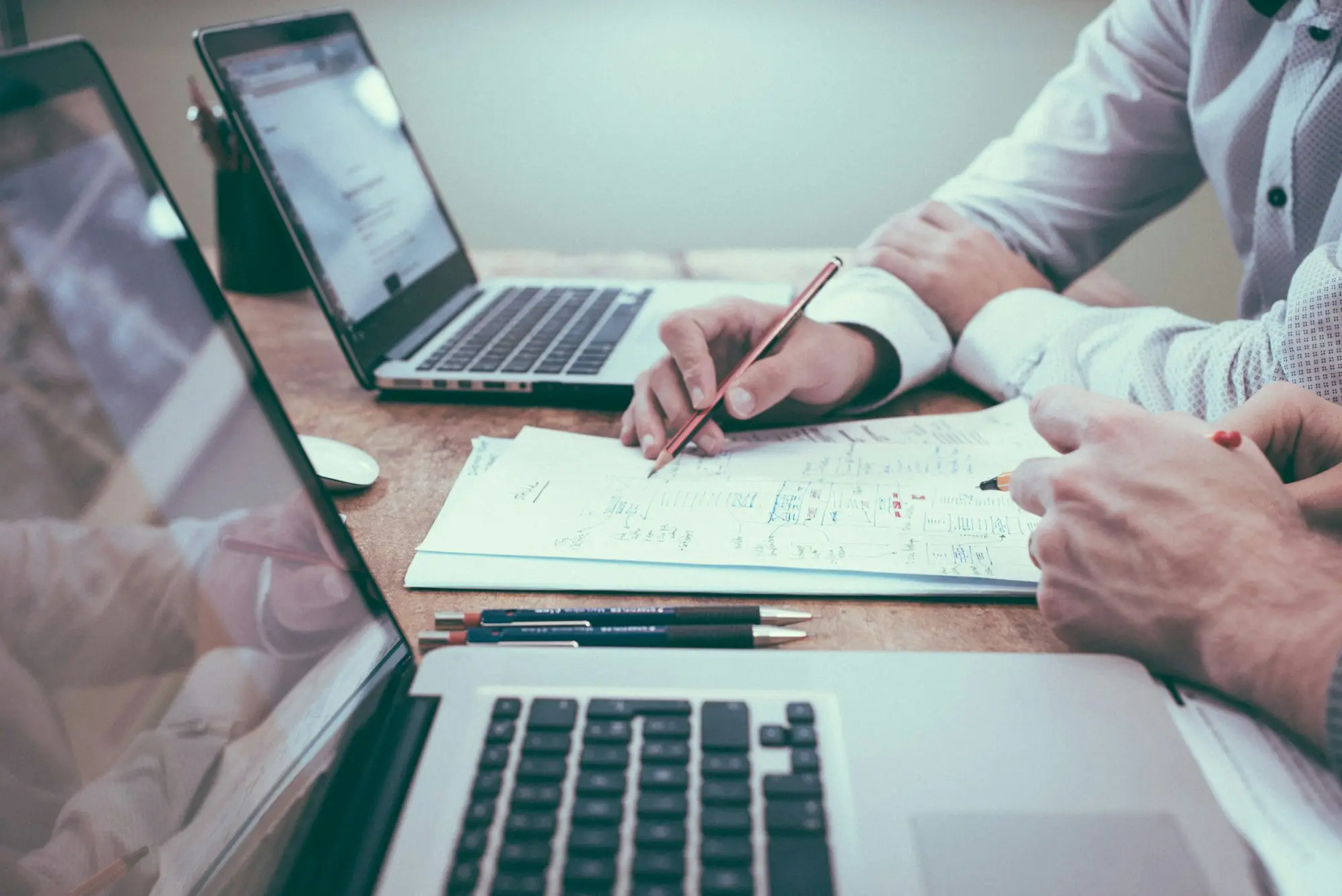 Accounts team reviewing an aged debtors report and other debtor finance documents before applying