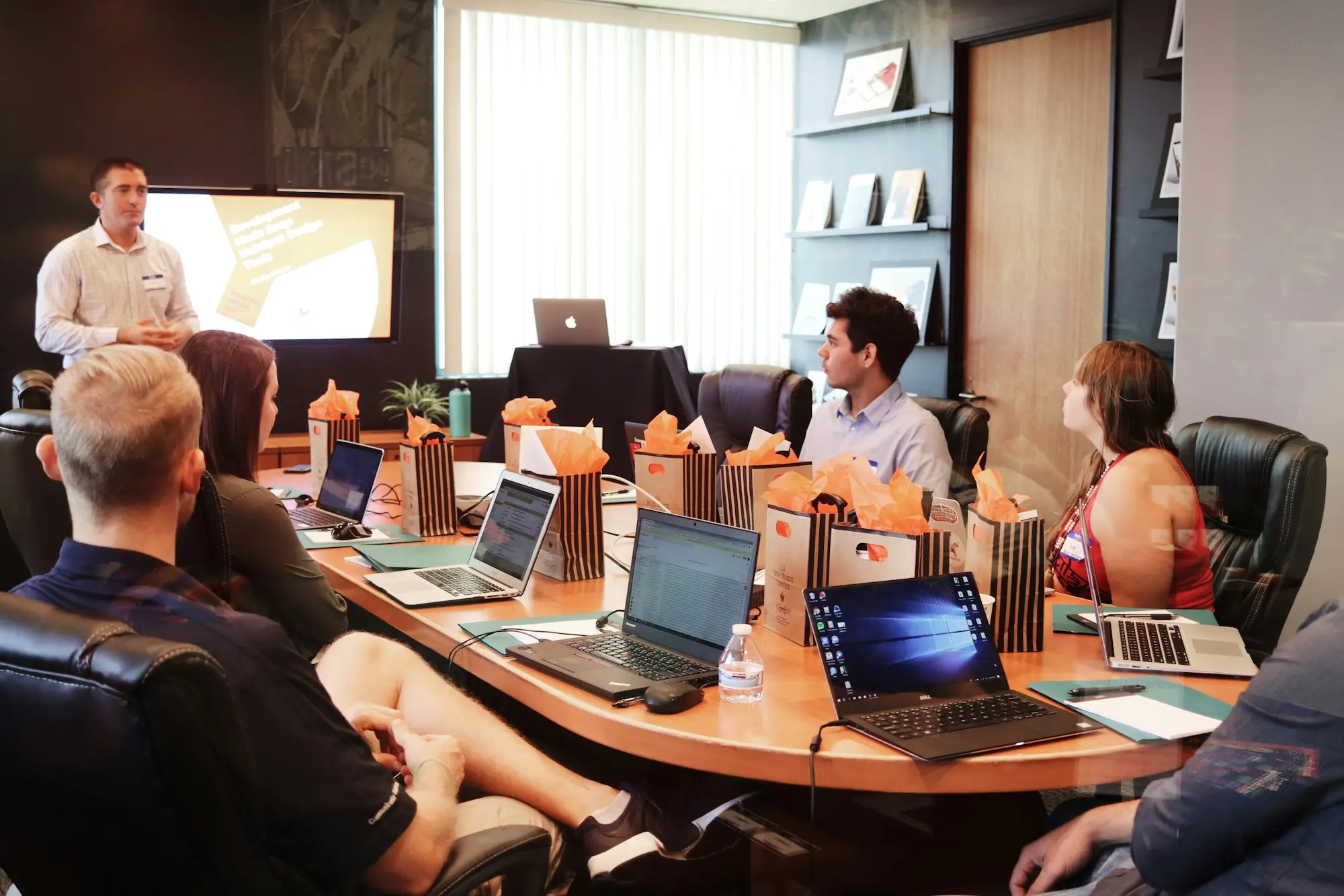 Accounts team in a meeting reviewing the debtor ledger behind a debtor finance facility