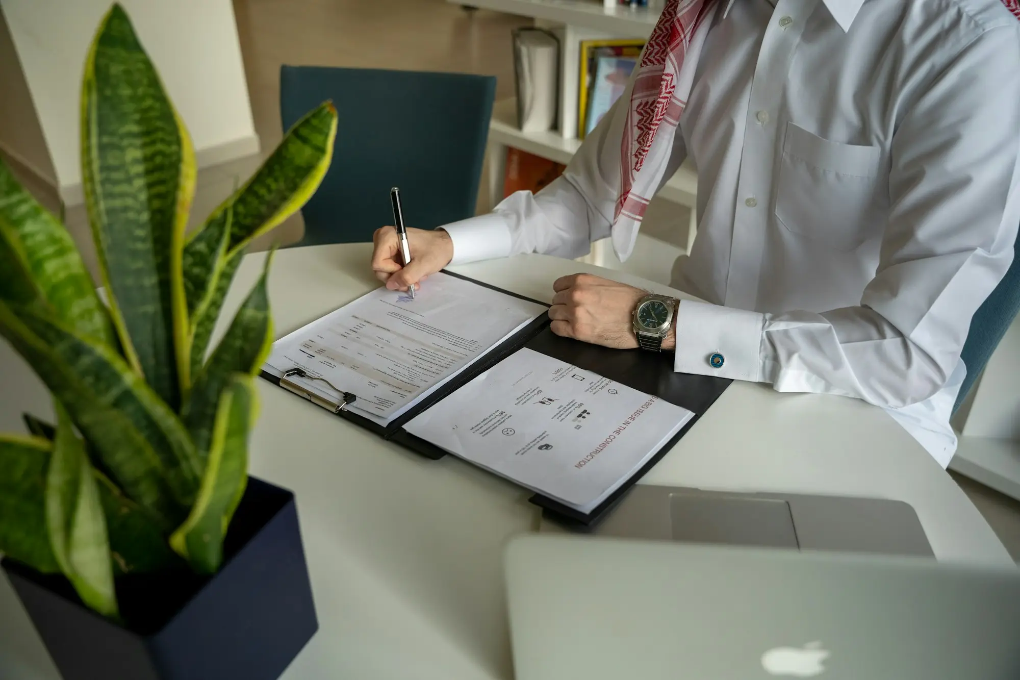 Business owner reading a contract and delivery dockets at a desk while a customer disputes an invoice
