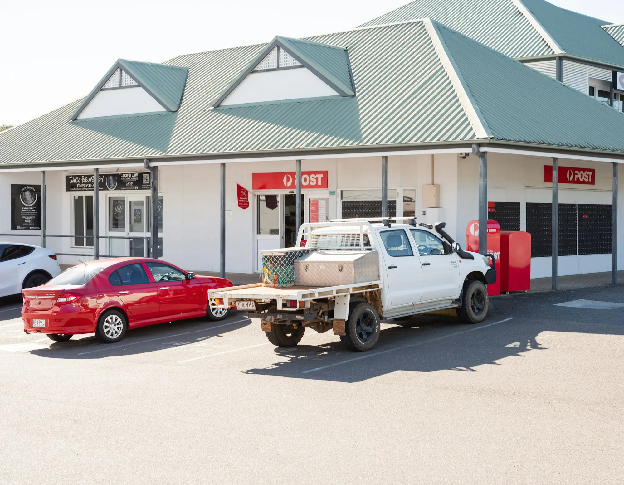 Tradie checking an ATO payment plan on a laptop beside a work ute before applying for equipment finance