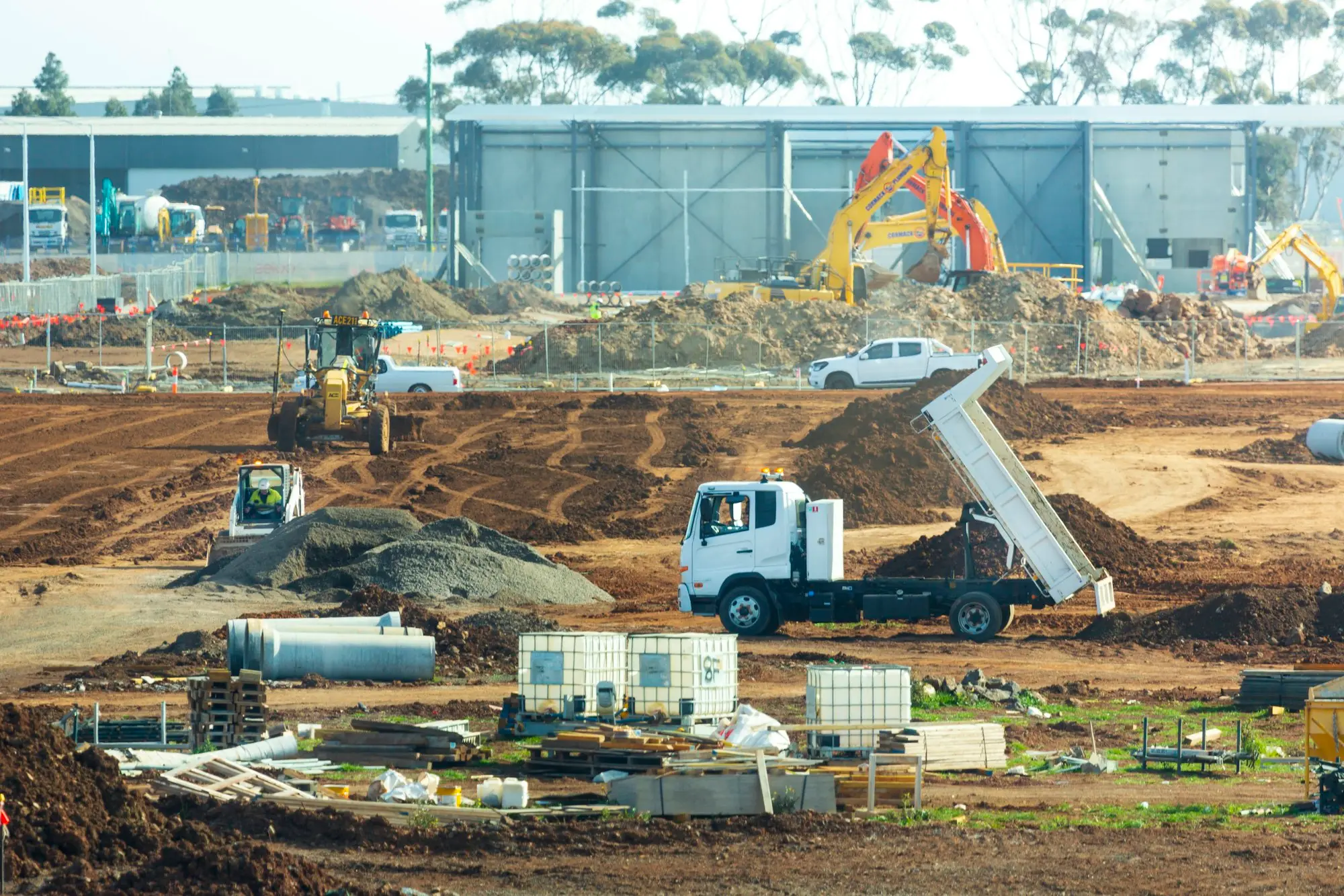 Excavator on an earthworks site, the kind of financed equipment weighed up in a business debt consolidation