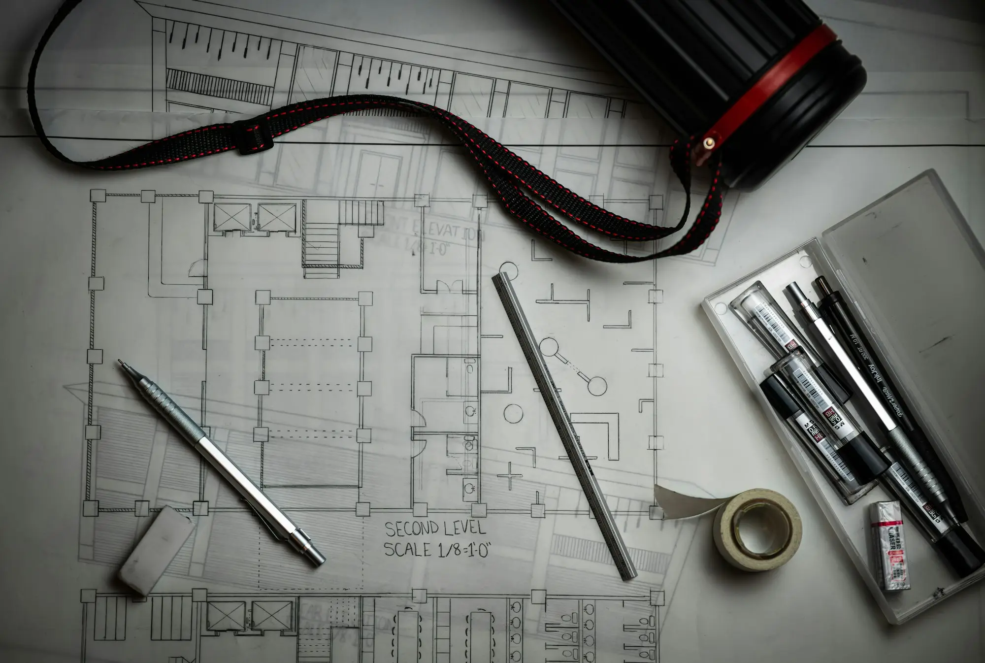 Architect reviewing building plans at a studio desk