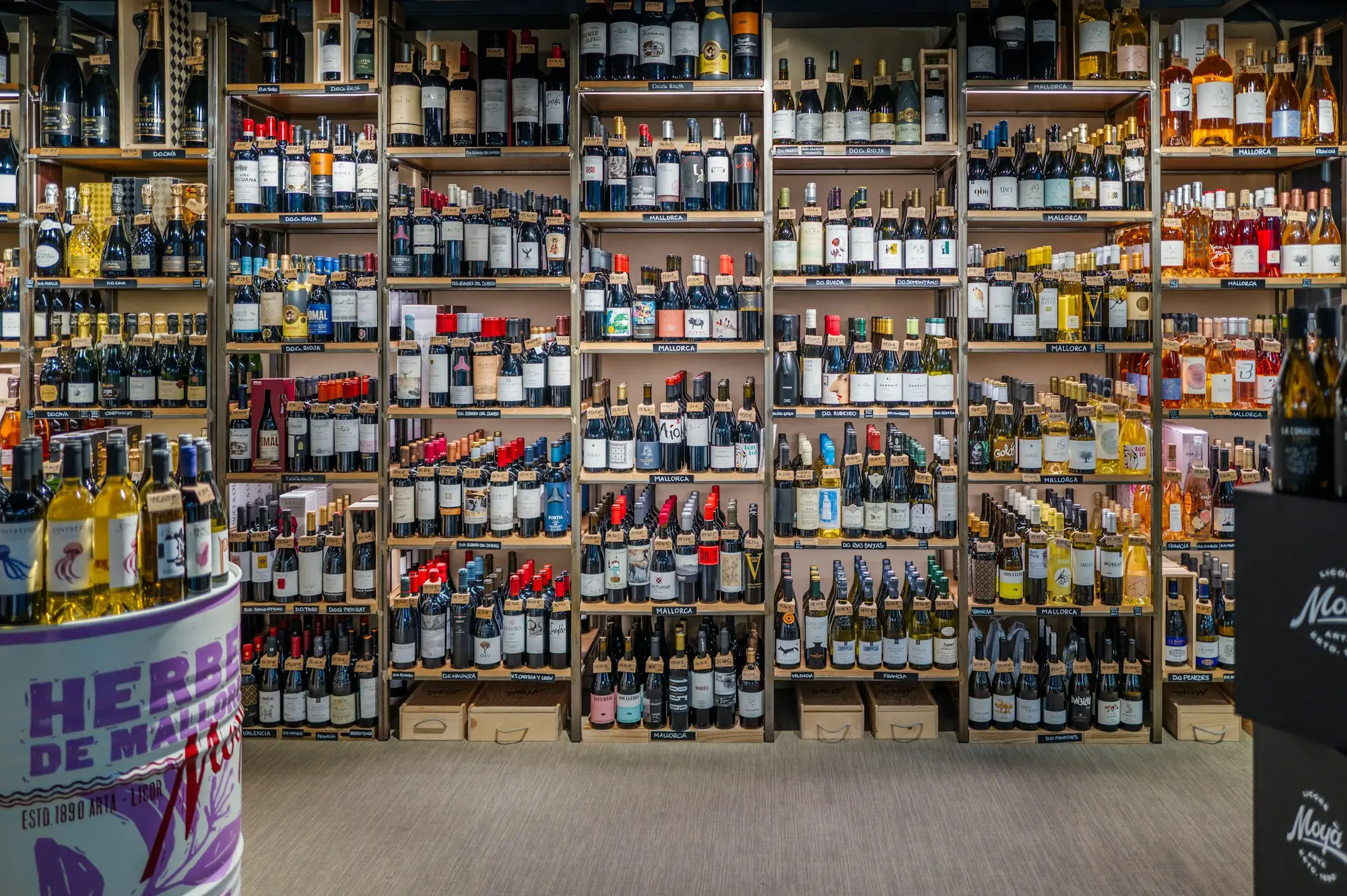 Aisle of wine bottles on shelves in an independent bottle shop