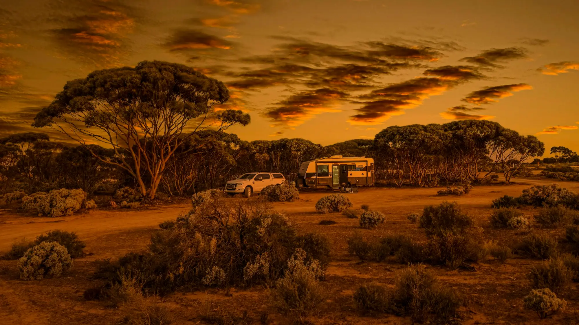 Cabins and powered caravan sites at a coastal holiday park