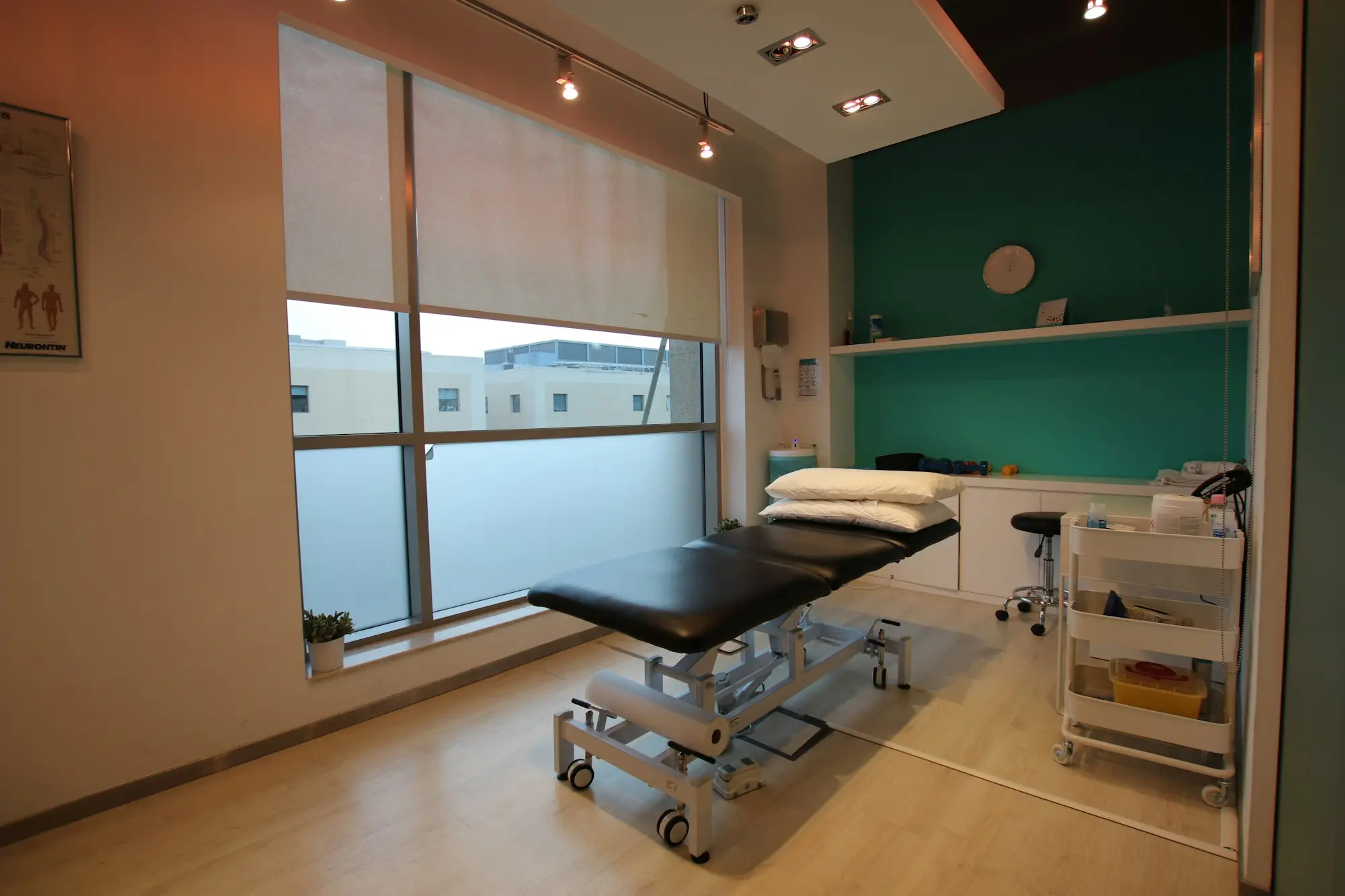 Chiropractic treatment room with an adjustable table in an allied health clinic