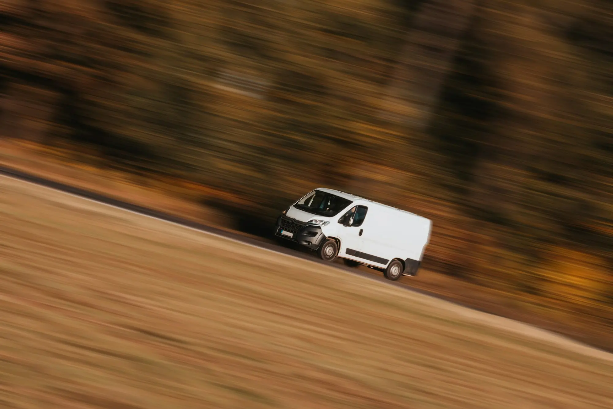 Courier unloading parcels from a delivery van for a last-mile run