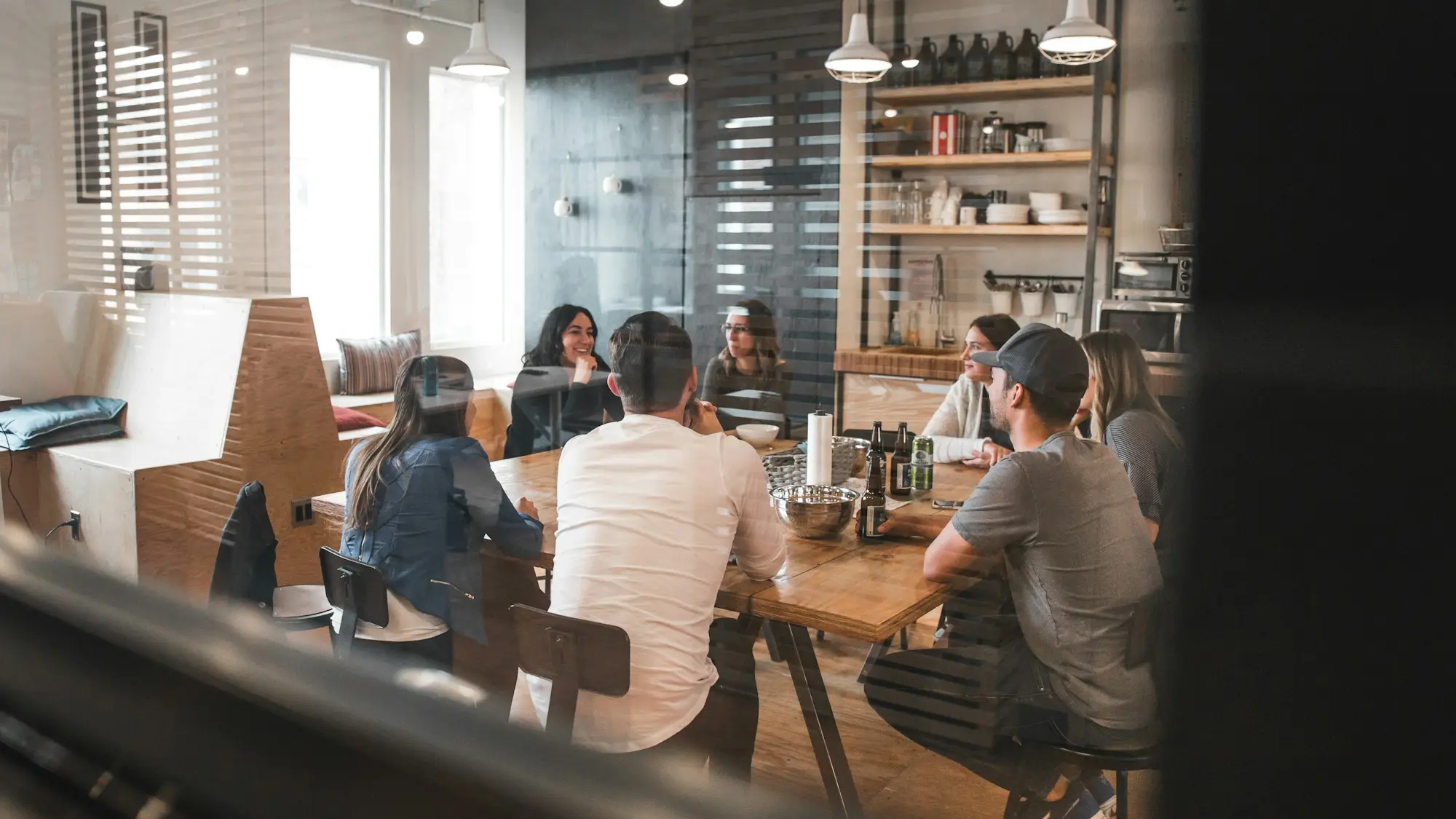 Creative agency team reviewing a campaign around a studio table