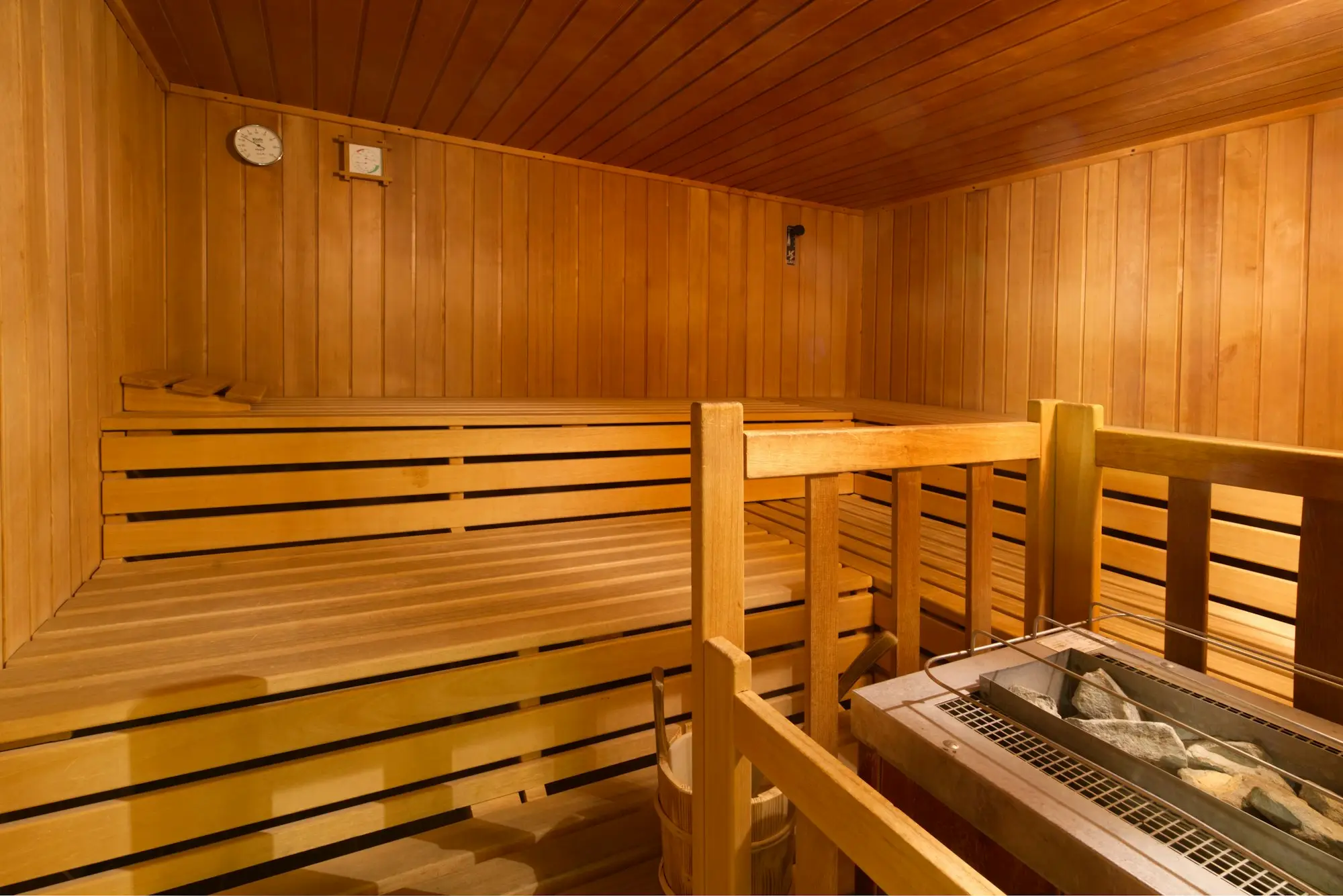 Day spa treatment room with a massage bed, towels and soft lighting