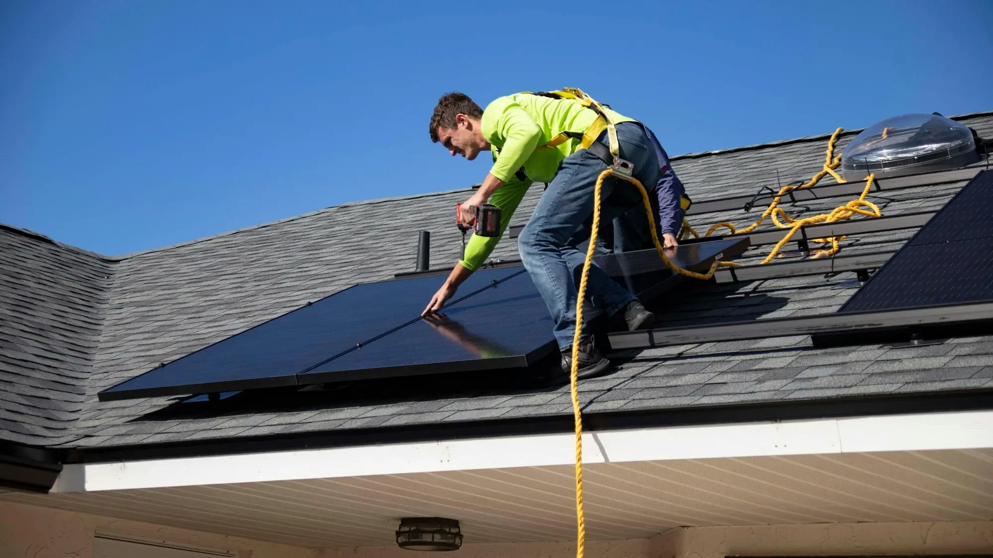 Installer fitting solar panels on a roof, an upgrade often paid for with green finance