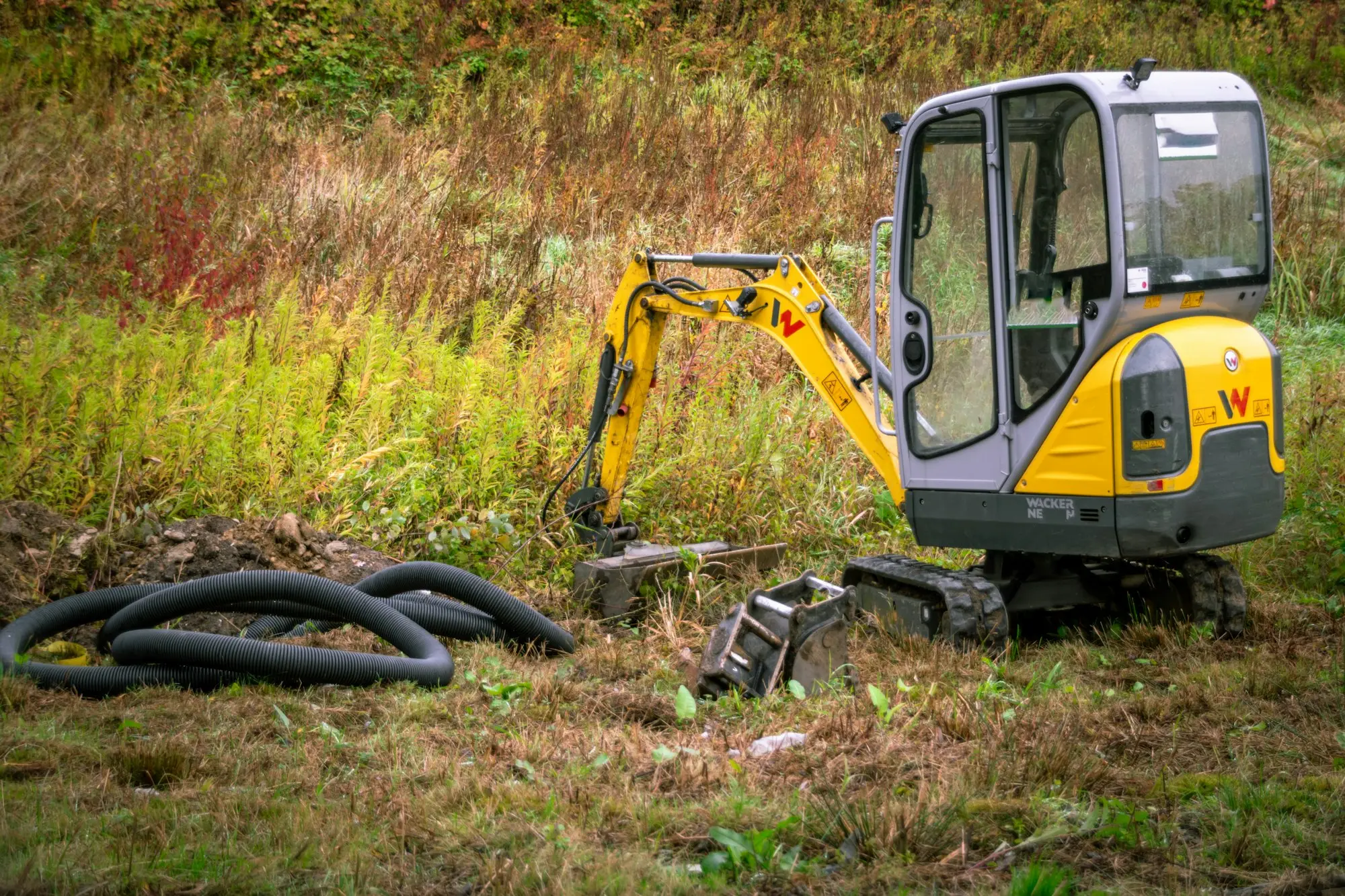 Mini excavator working on a landscaping site, seasonal equipment a business could hire or finance