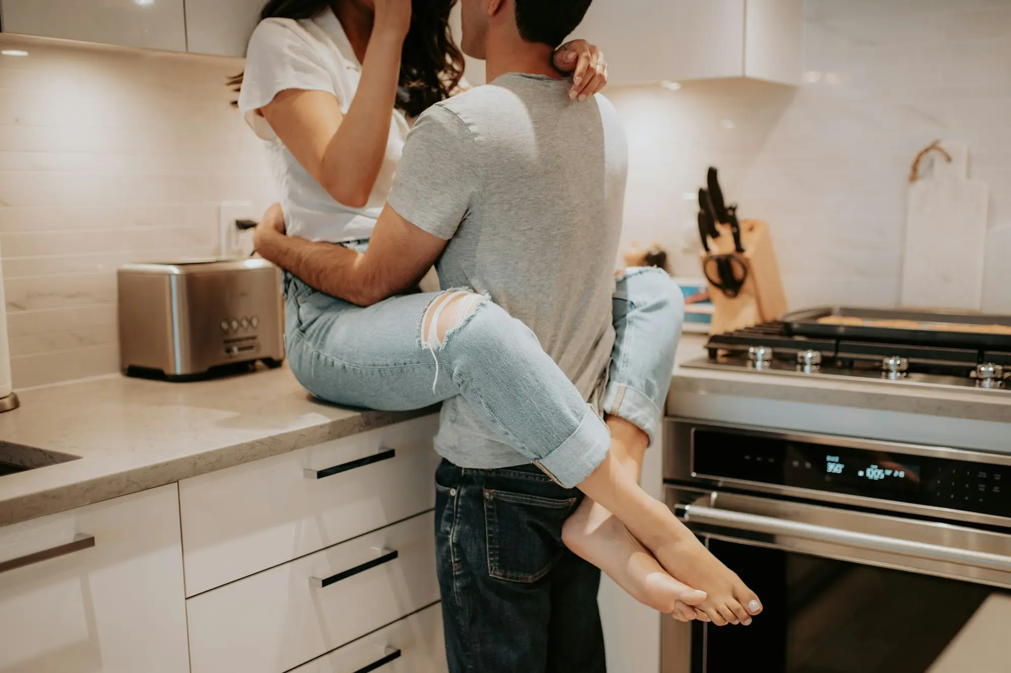 Couple working through the numbers at their kitchen bench on whether a home equity business loan affects the main residence CGT exemption