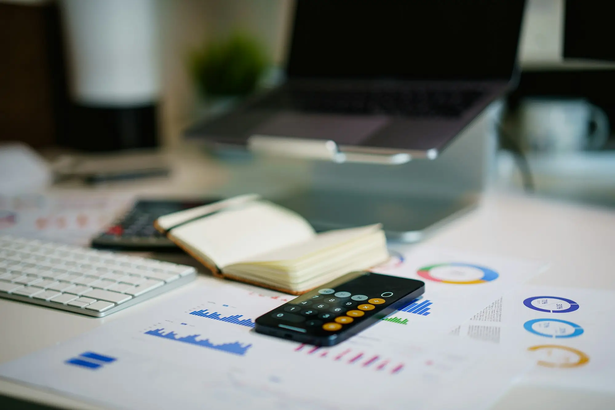 Bookkeeper with a calculator reconciling lender statements to work out whether invoice finance fees are tax deductible