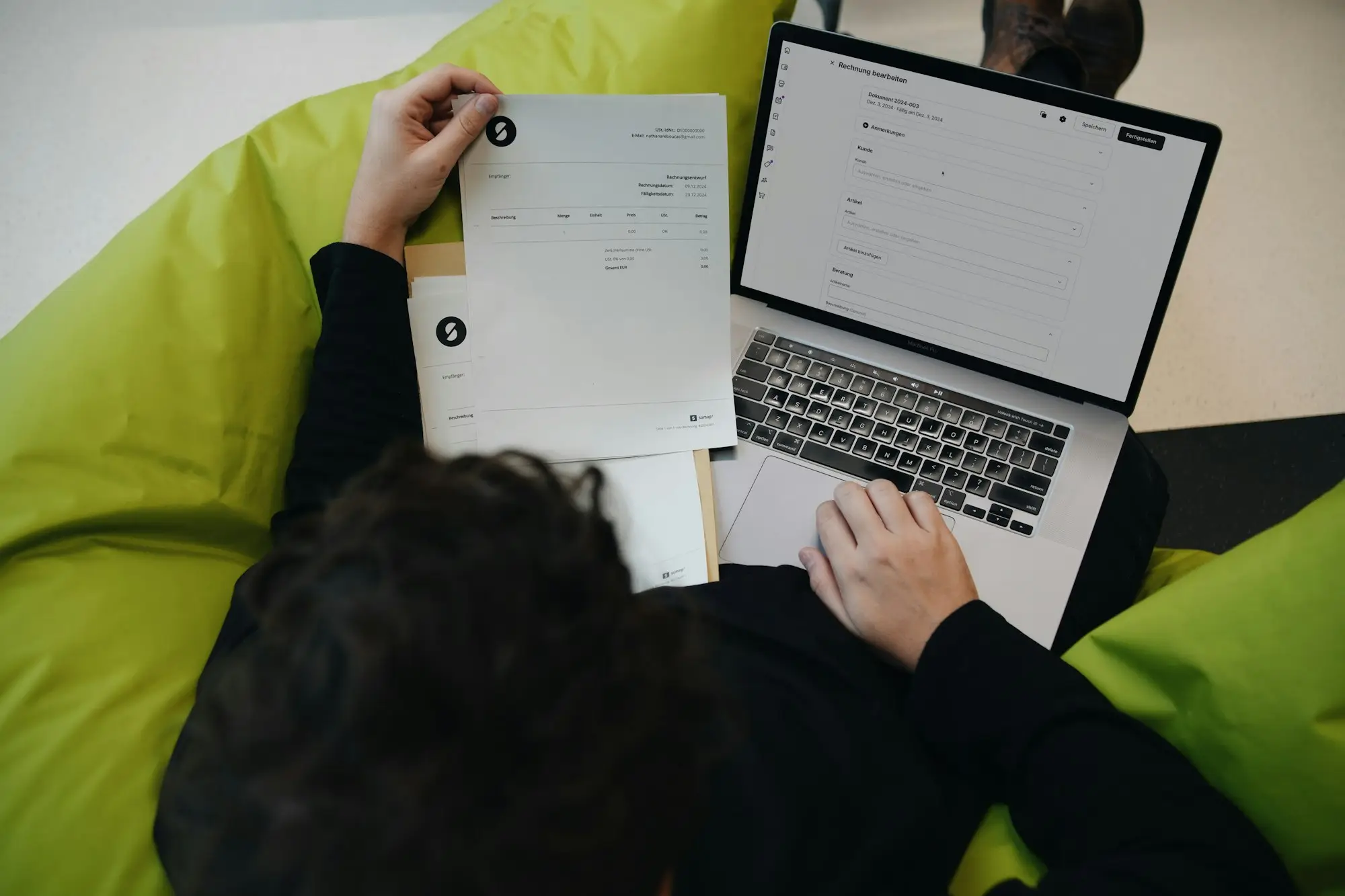 Consultant preparing an invoice on a laptop for a government contract, a common use for invoice finance