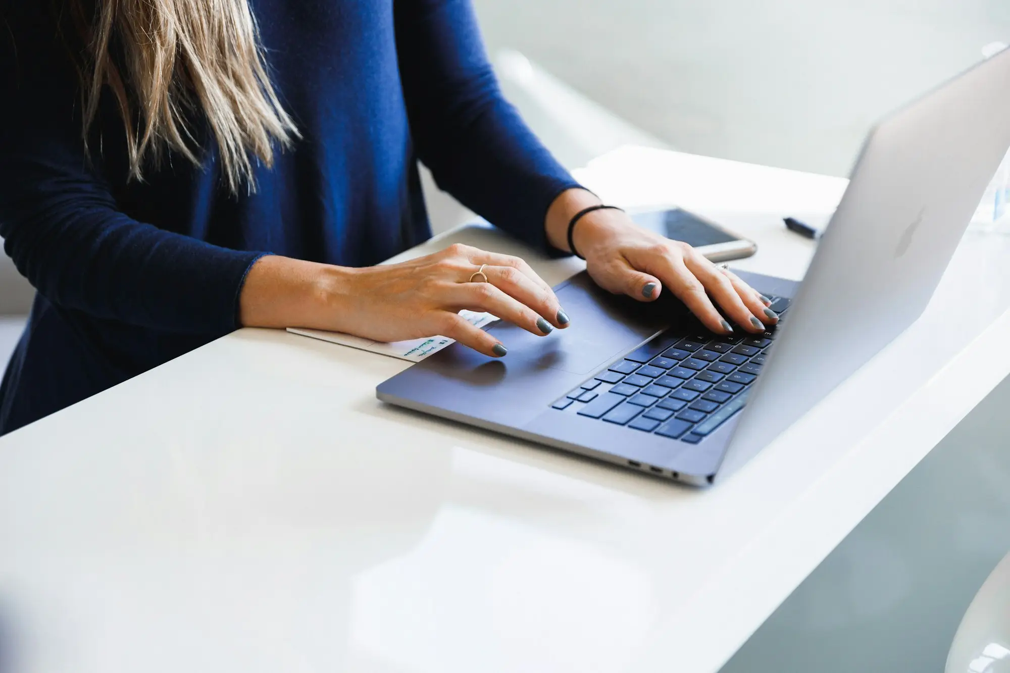 Bookkeeper at a laptop coding line of credit draws, repayments and interest for a small business BAS