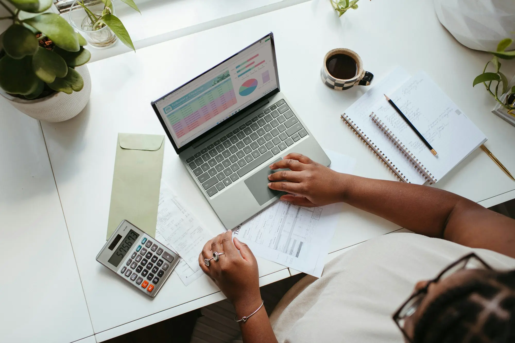 Business owner reviewing a line of credit statement at a kitchen table, separating private spending from business draws for tax