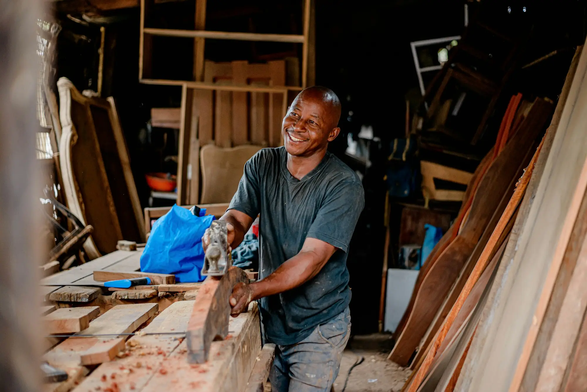 Smiling carpenter in his workshop, a self-employed owner who may suit a low doc business loan