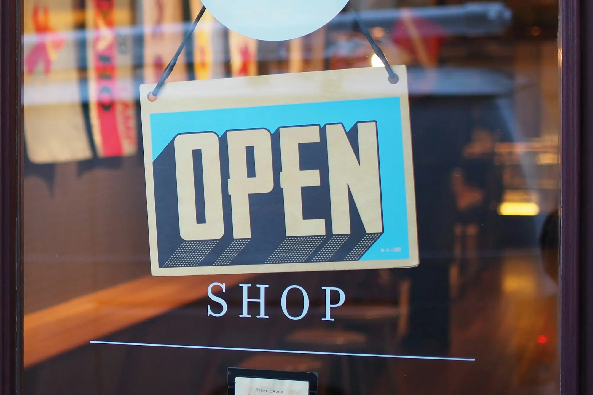 Open sign on the door of a new small shop starting out with a new business loan