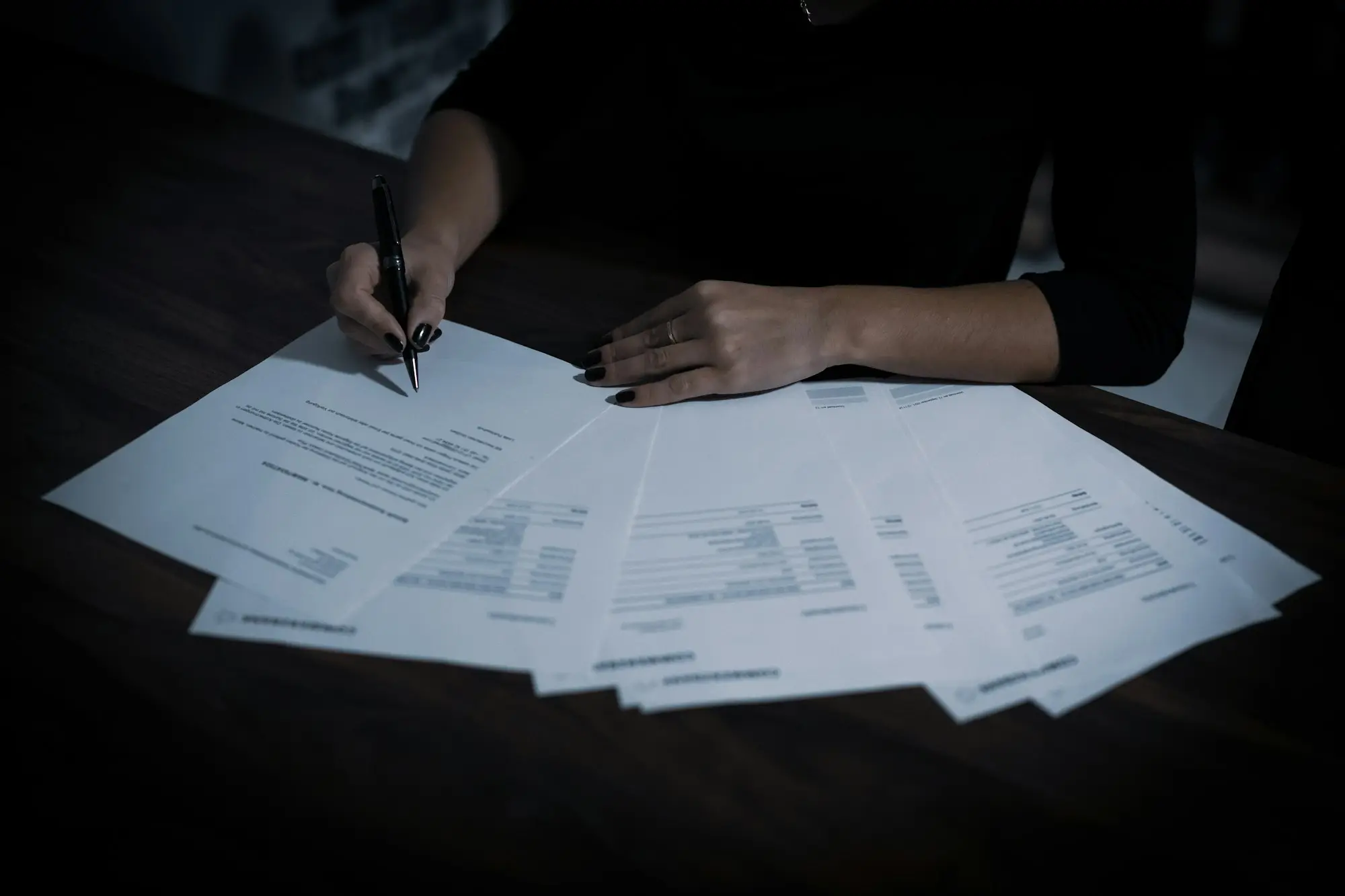 Owner highlighting a large one-off deposit on a printed business bank statement before sending it to a lender