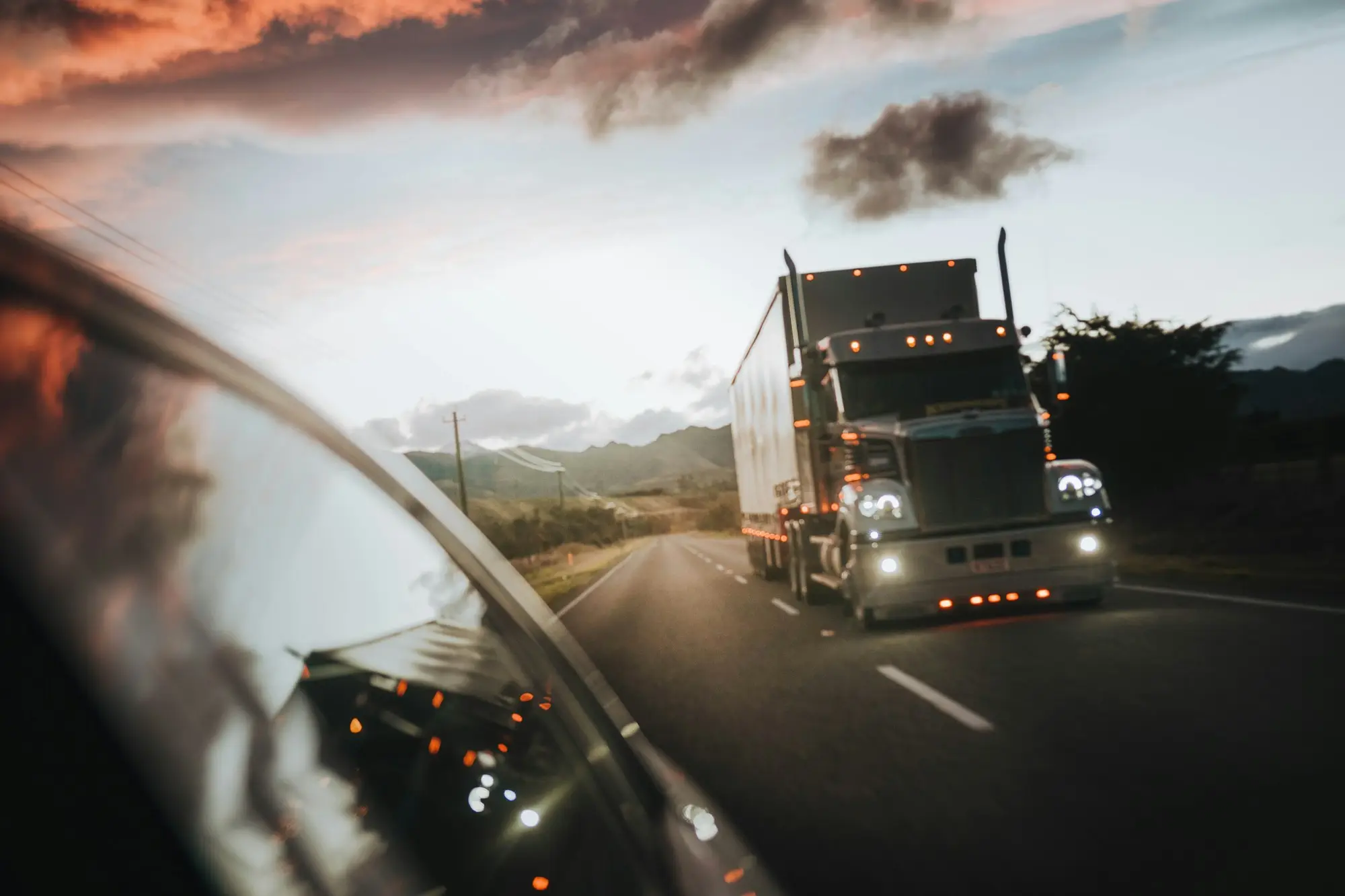 Owner-driver at the wheel of a prime mover at sunrise, ready for the first run on a newly financed truck