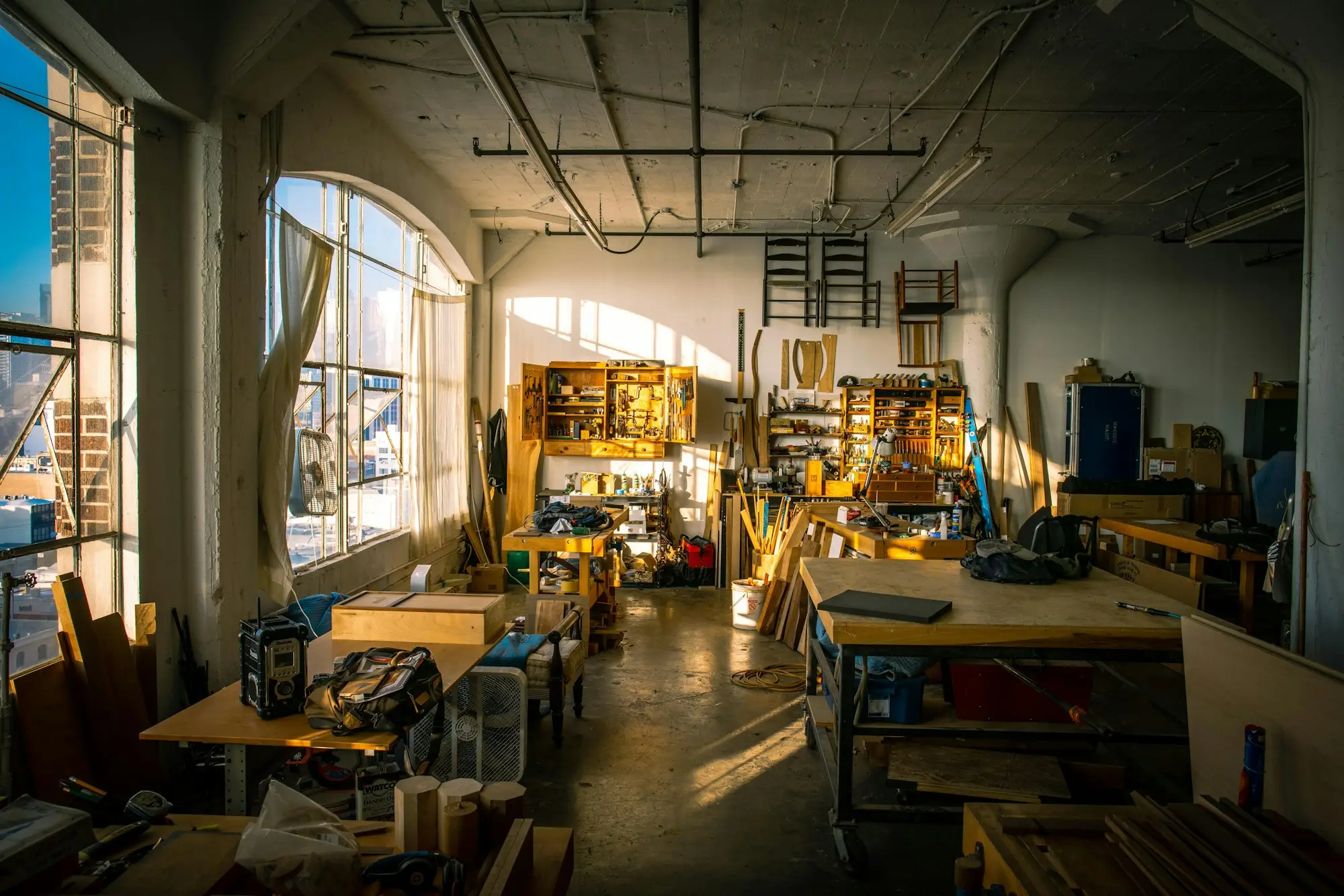 Cabinet maker building custom joinery in a workshop, a business paid on completion that relies on cash flow funding