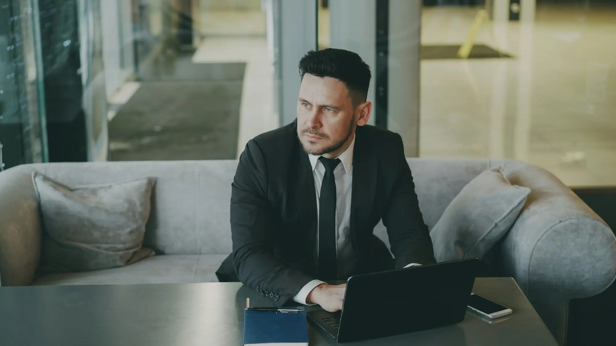 Surviving business owner sitting alone in the office reviewing papers for a partner buyout after death or illness