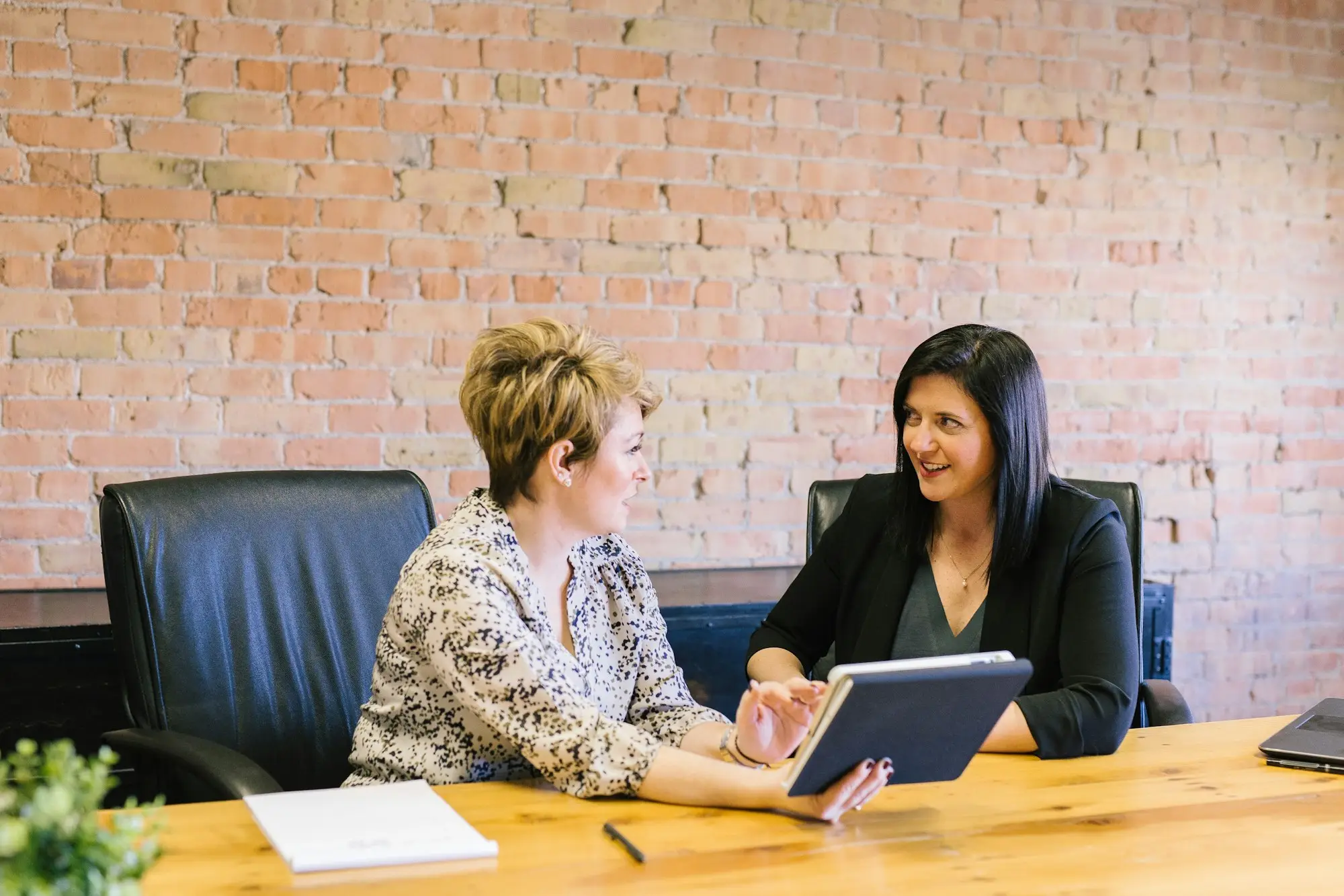 Business partners meeting around a table to plan a partner buyout