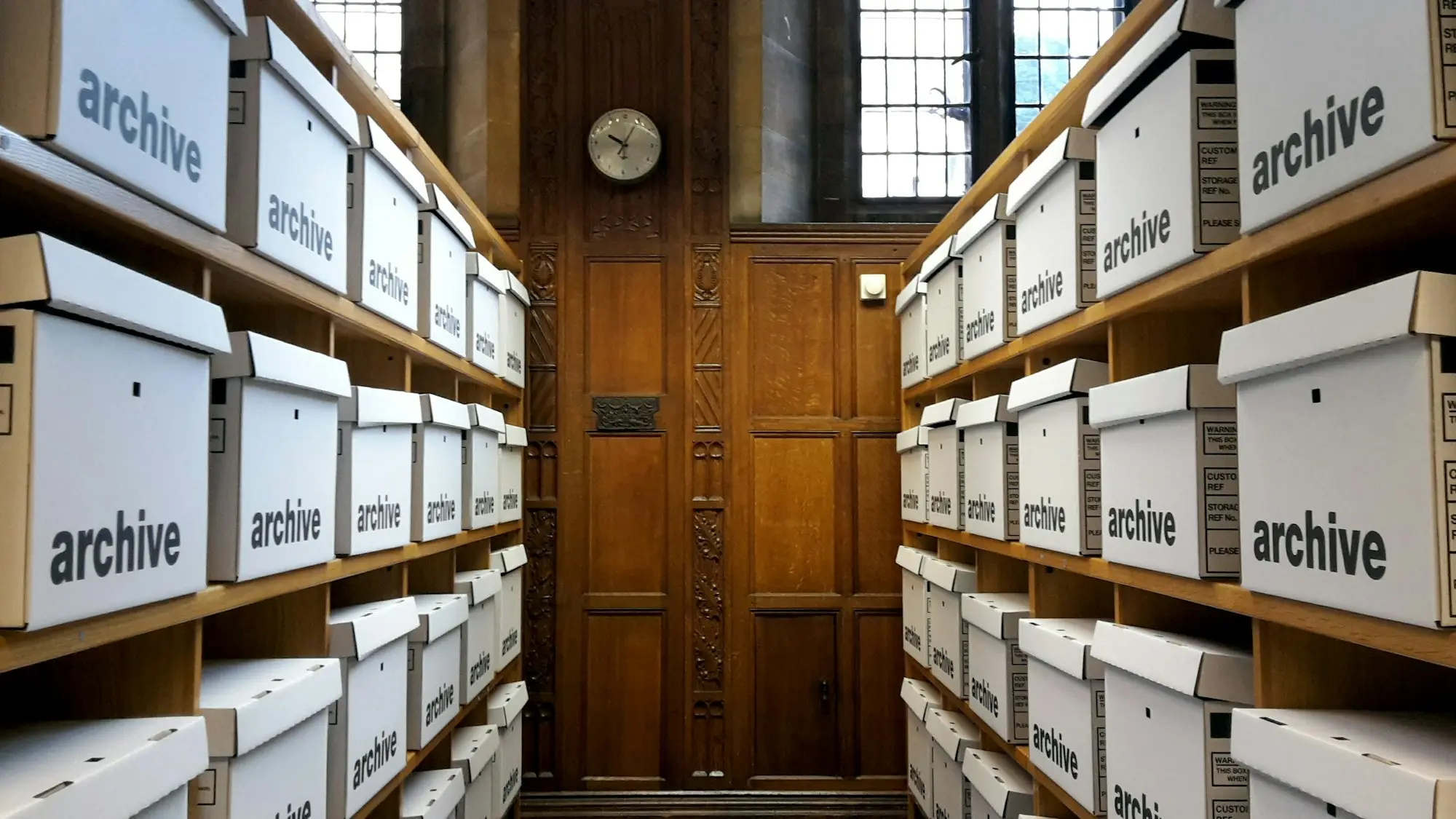 Stacks of returned product boxes in a small business stockroom during a product recall, waiting for refunds and disposal