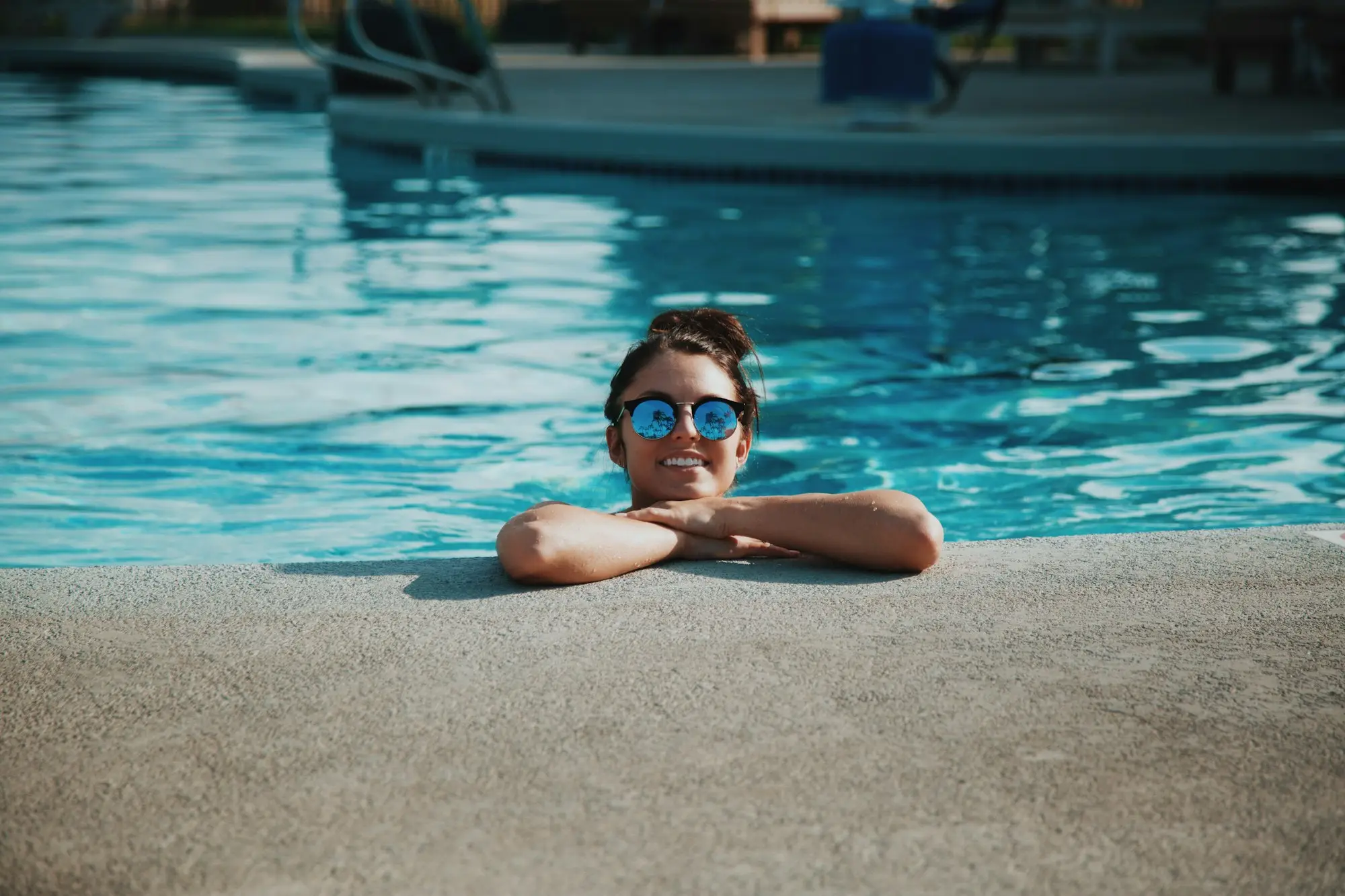 Pool technician servicing a backyard pool in summer, the busy months when a seasonal business makes most of its loan repayments
