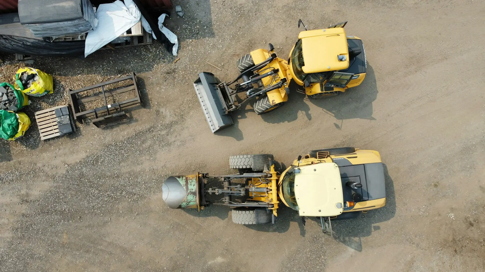 Used excavator parked in an equipment yard, ready to be sold while finance is still owing on it