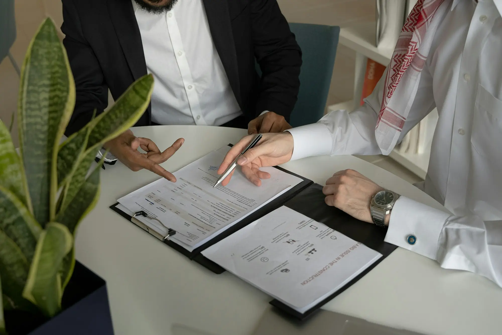 Company directors signing share buy-back documents as a departing shareholder exits the business