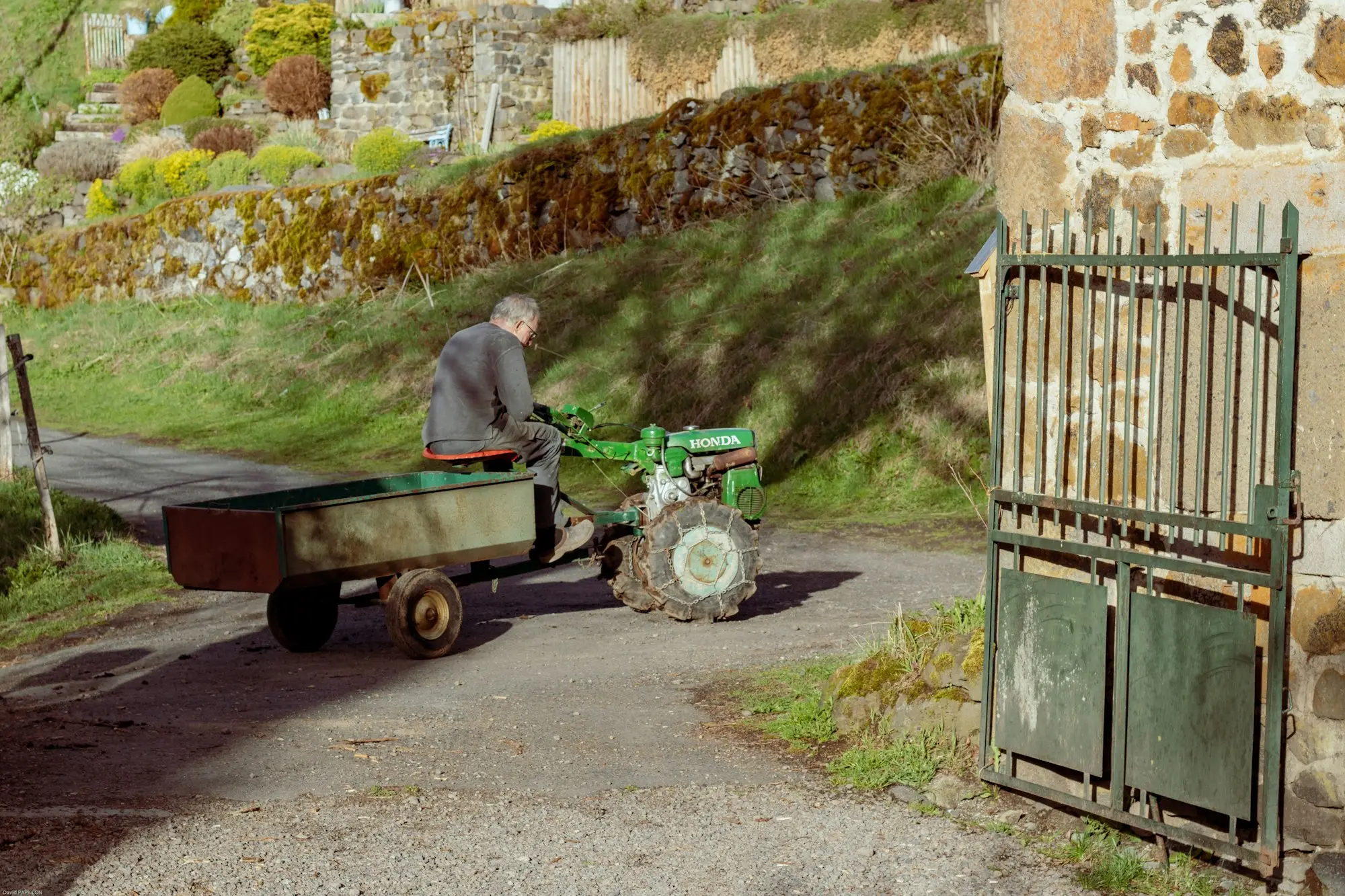 Compact tractor with a front-end loader working on a small farm block, the kind of machine financed through small-farm tractor finance