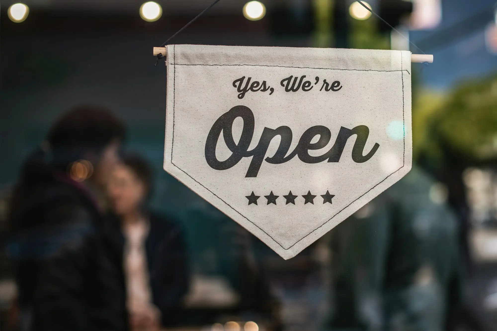 Small business owner standing outside premises held in a self-managed super fund, wondering if it can secure a business loan