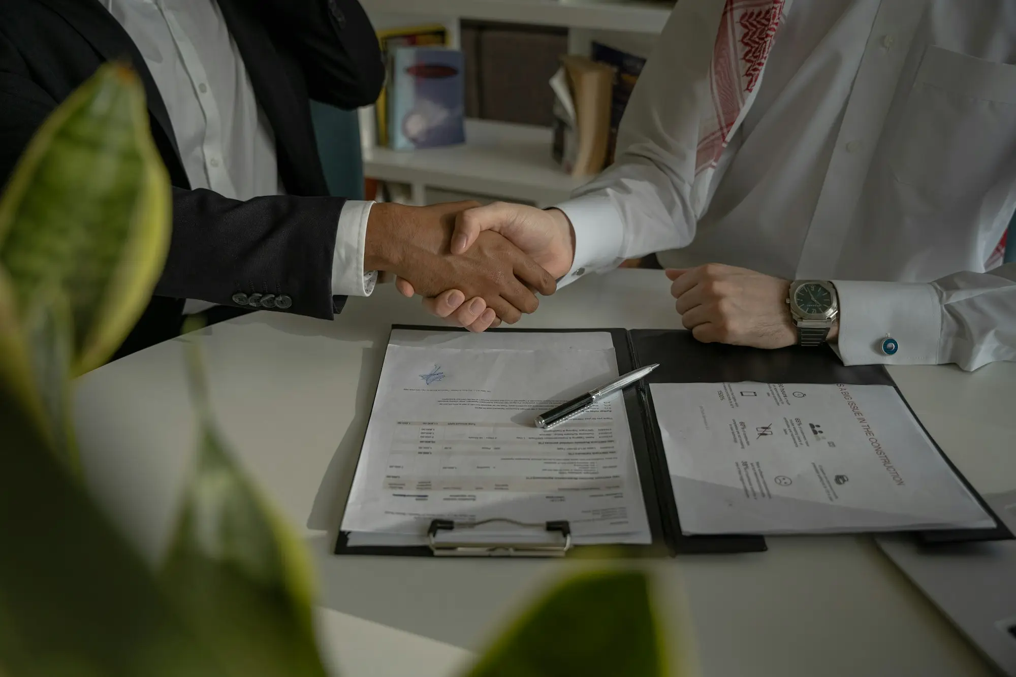 Two directors signing company registration documents for a new single-purpose development company before applying for a development loan
