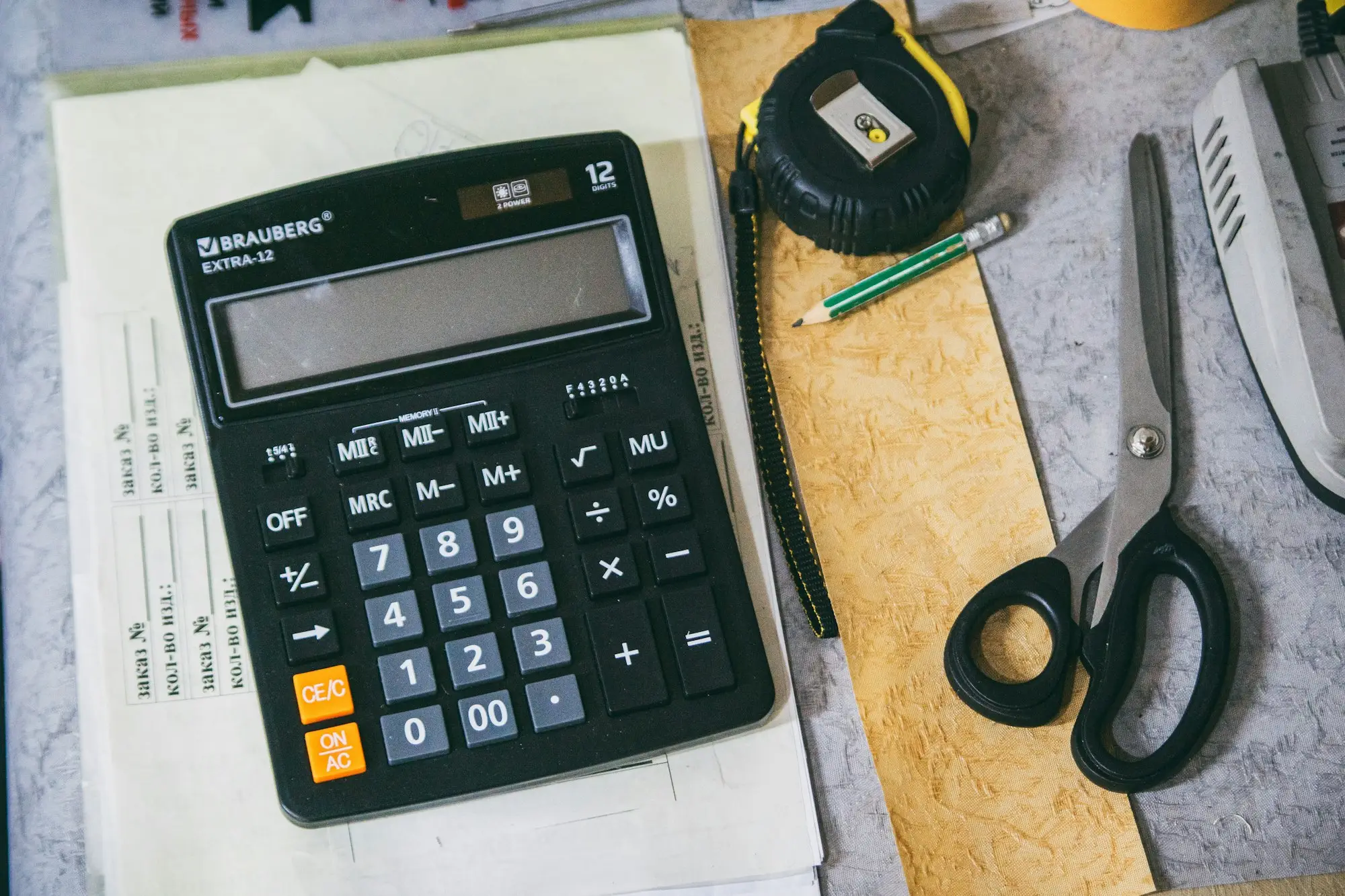 Accountant and business owner reviewing stock figures to work out whether stock bought with a business loan is tax deductible