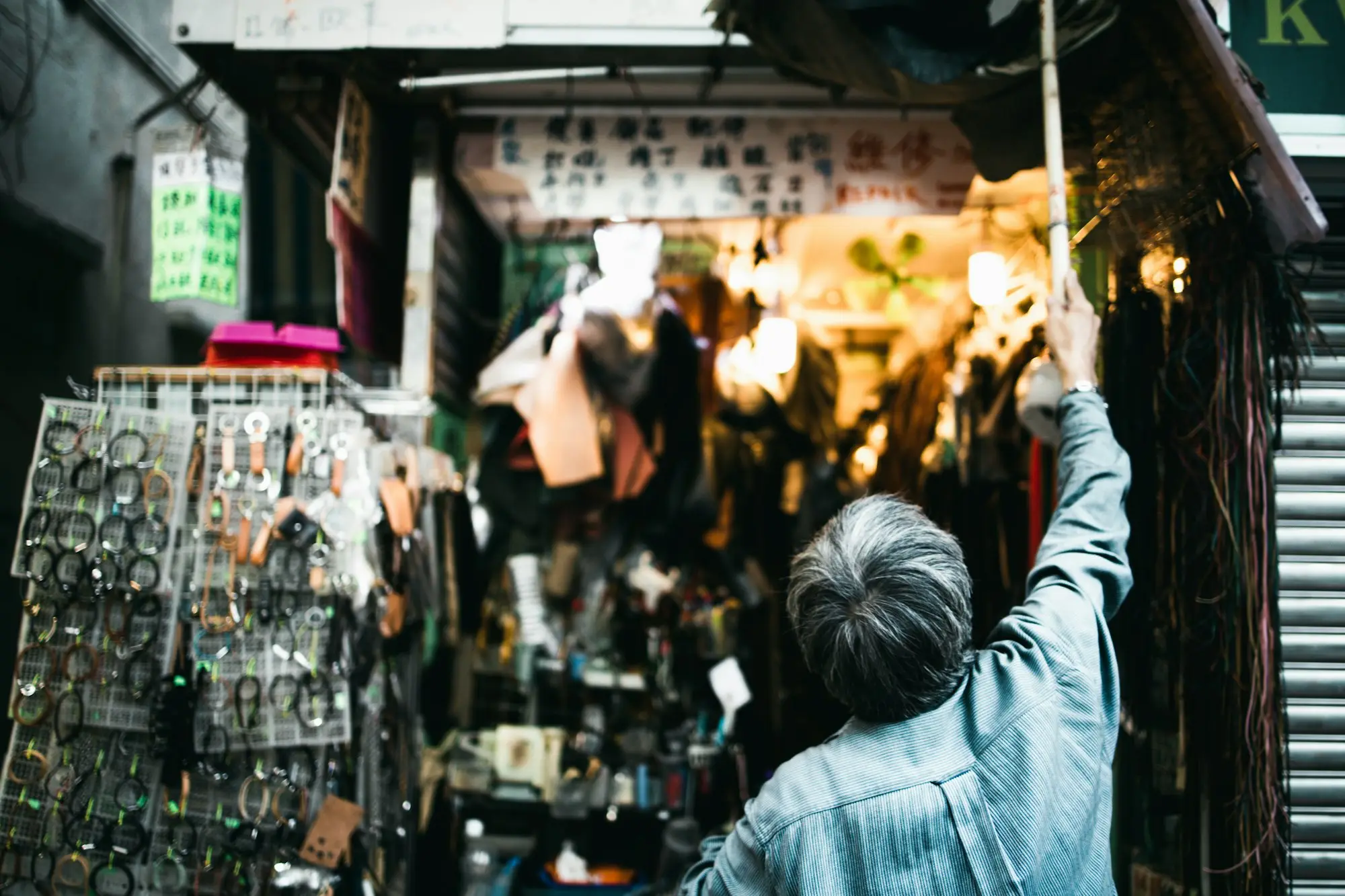 Retail shop owner holding the shop keys outside a strip-shop storefront with a lease coming up for renewal
