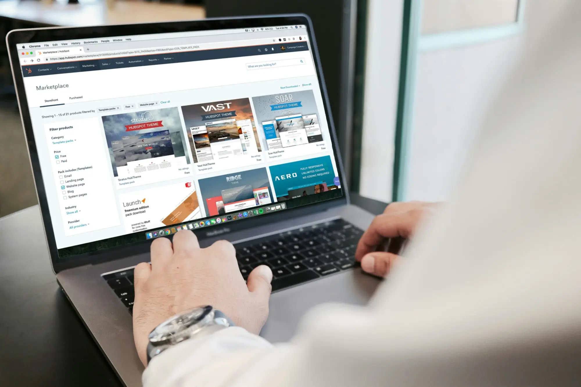 Business owner comparing several business bank account statements on a laptop before applying for an unsecured loan