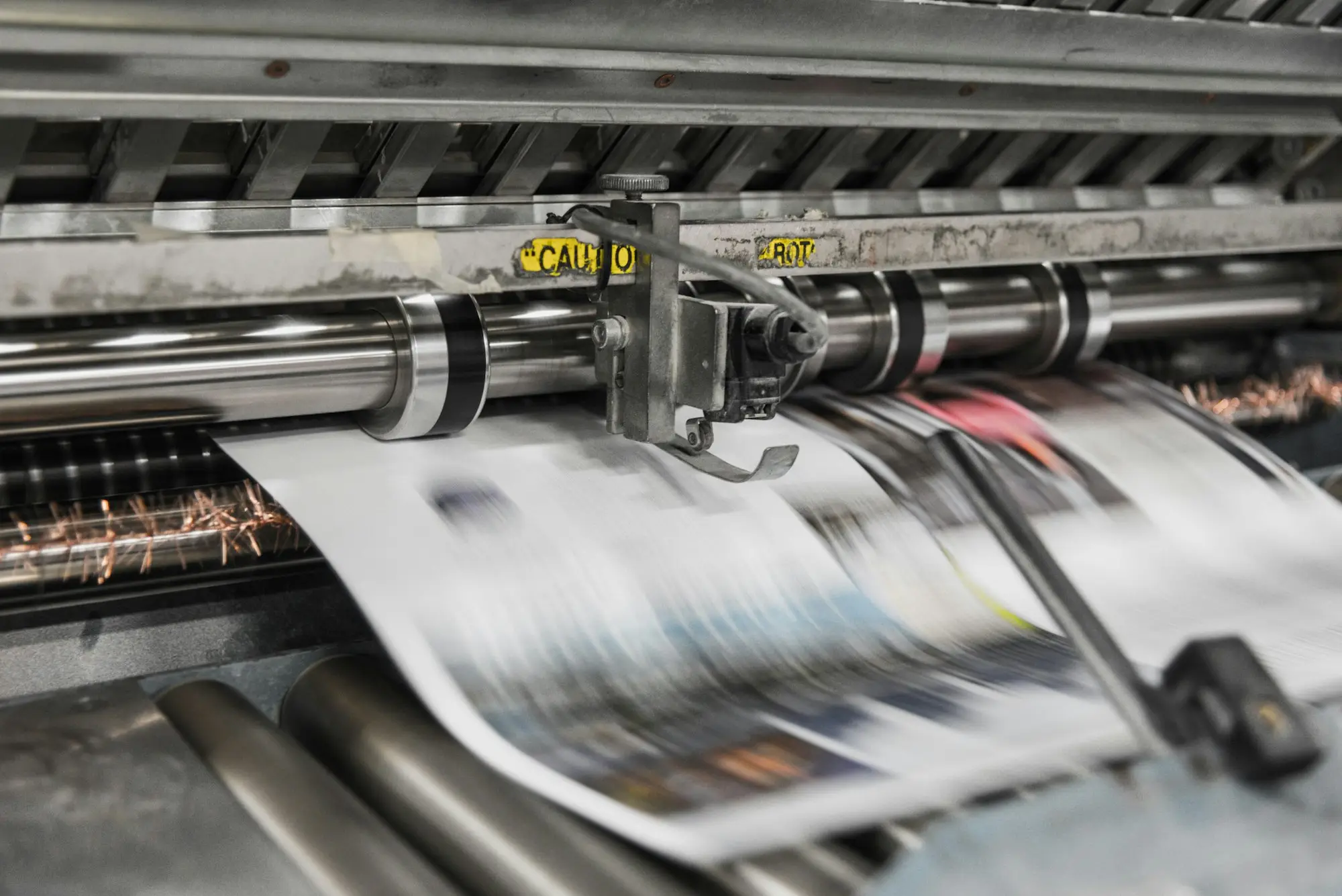 New wide-format printer being set up in a print shop upgrading equipment before the old finance ends